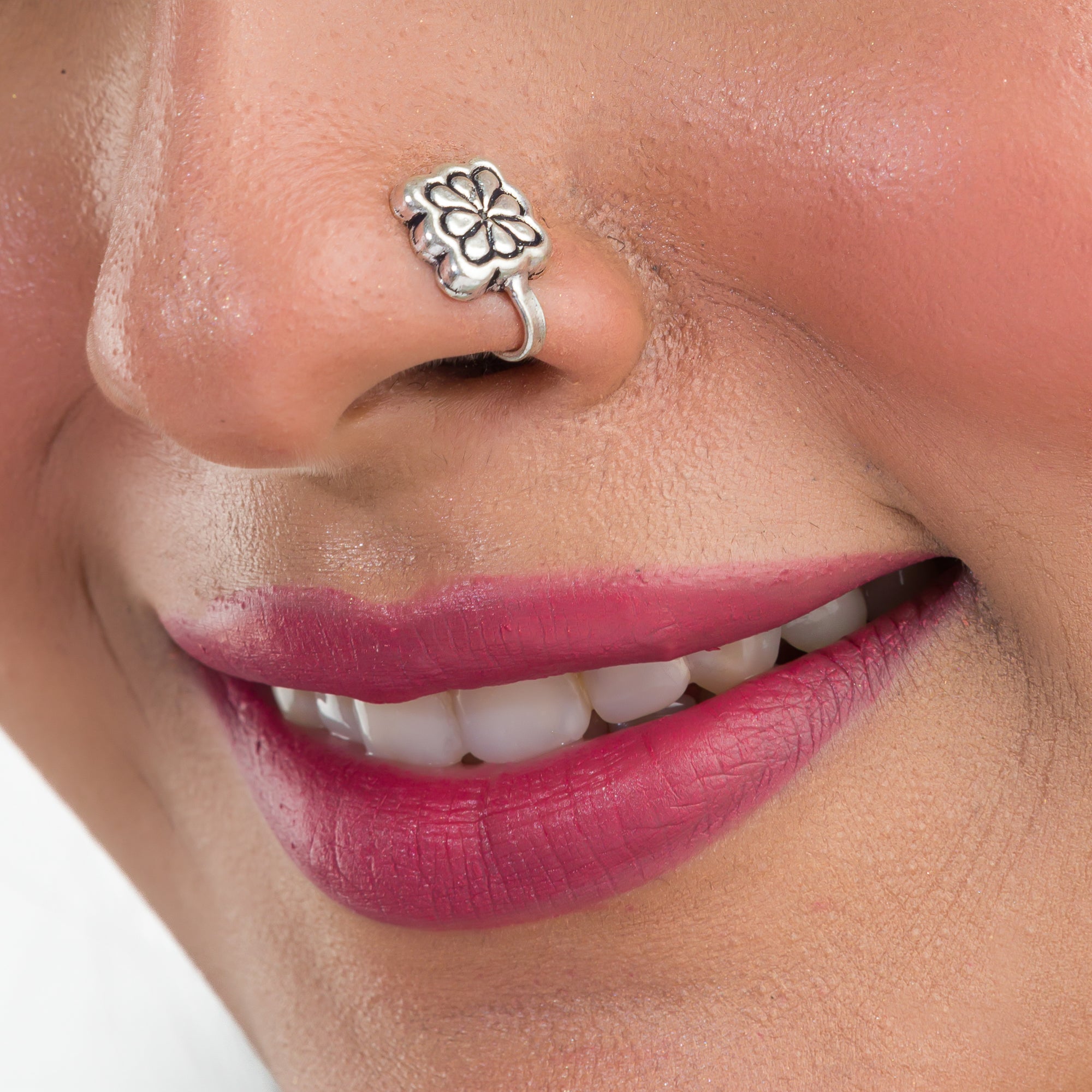 1. "Oxidized silver nose pin, perfect for festival wear, adding an understated, vintage-inspired charm."