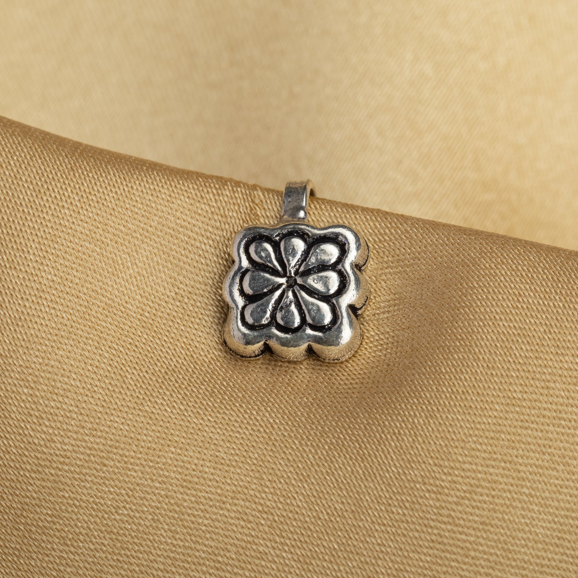1. "Oxidized silver nose pin, perfect for festival wear, adding an understated, vintage-inspired charm."