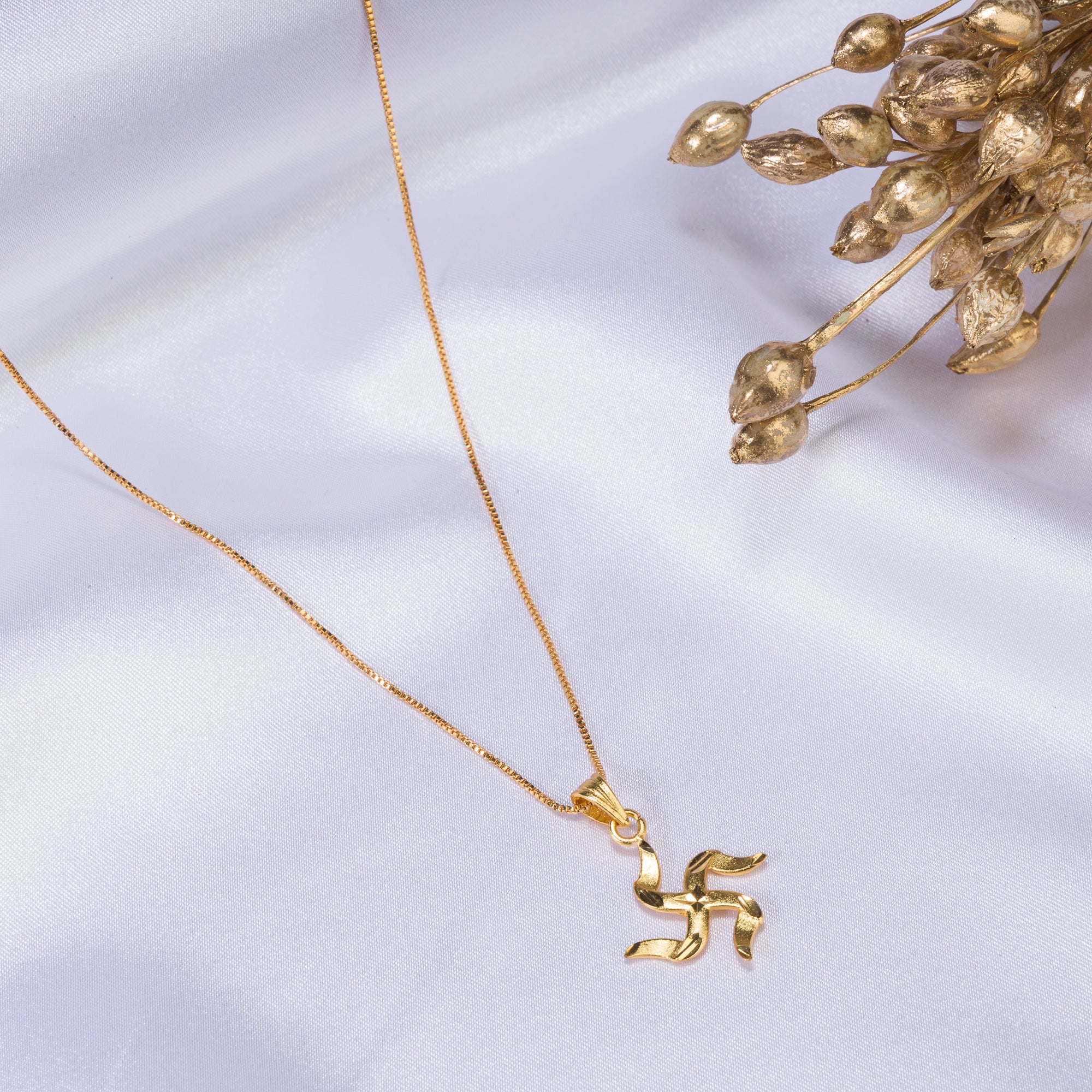 Elegant gold-tone pendant with a Swastik design, perfect for casual wear, adding a meaningful touch."