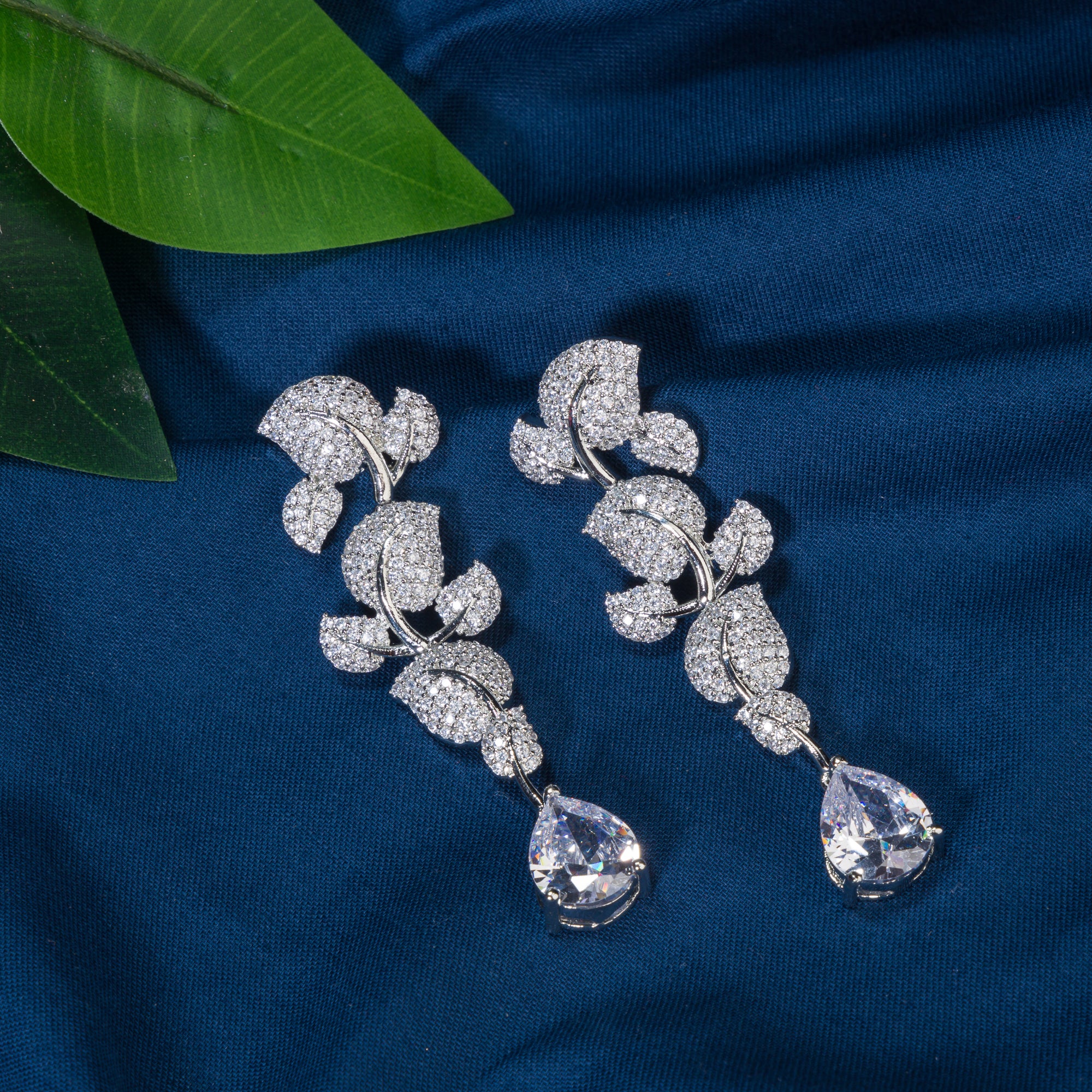 "Leaf design zircon earrings blend nature’s beauty with radiant zircon accents."