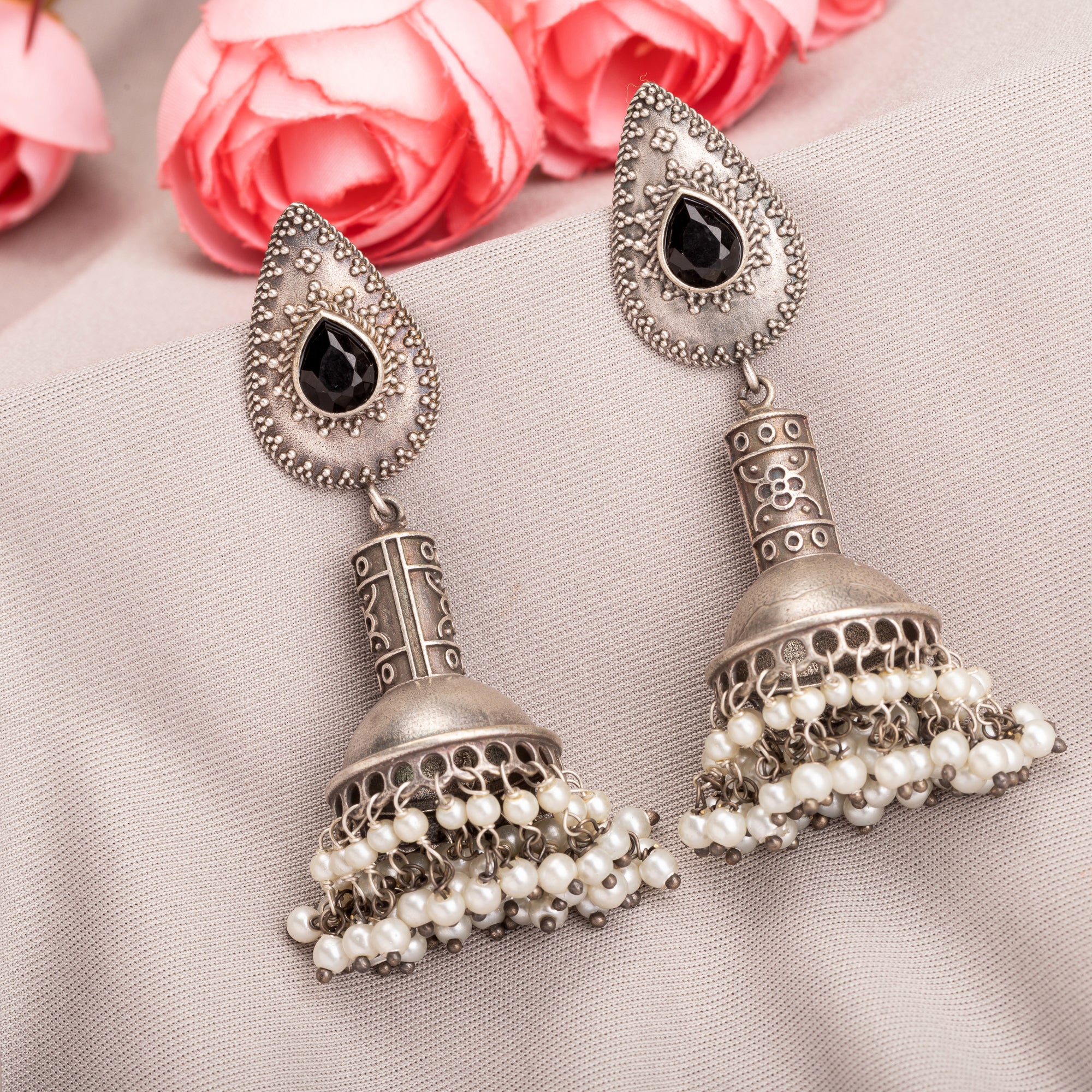 "Oxidized jhumka with black stone delivers a striking vintage allure for a timeless style."