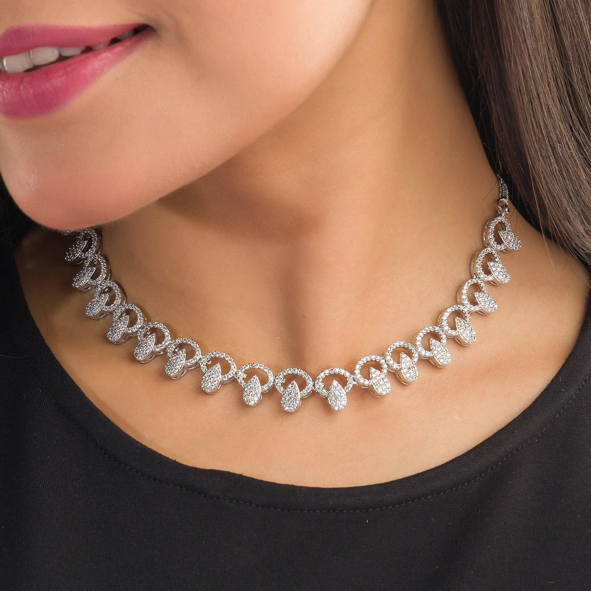 "Zircon necklace with large stone drop adds dramatic sparkle and elegance."