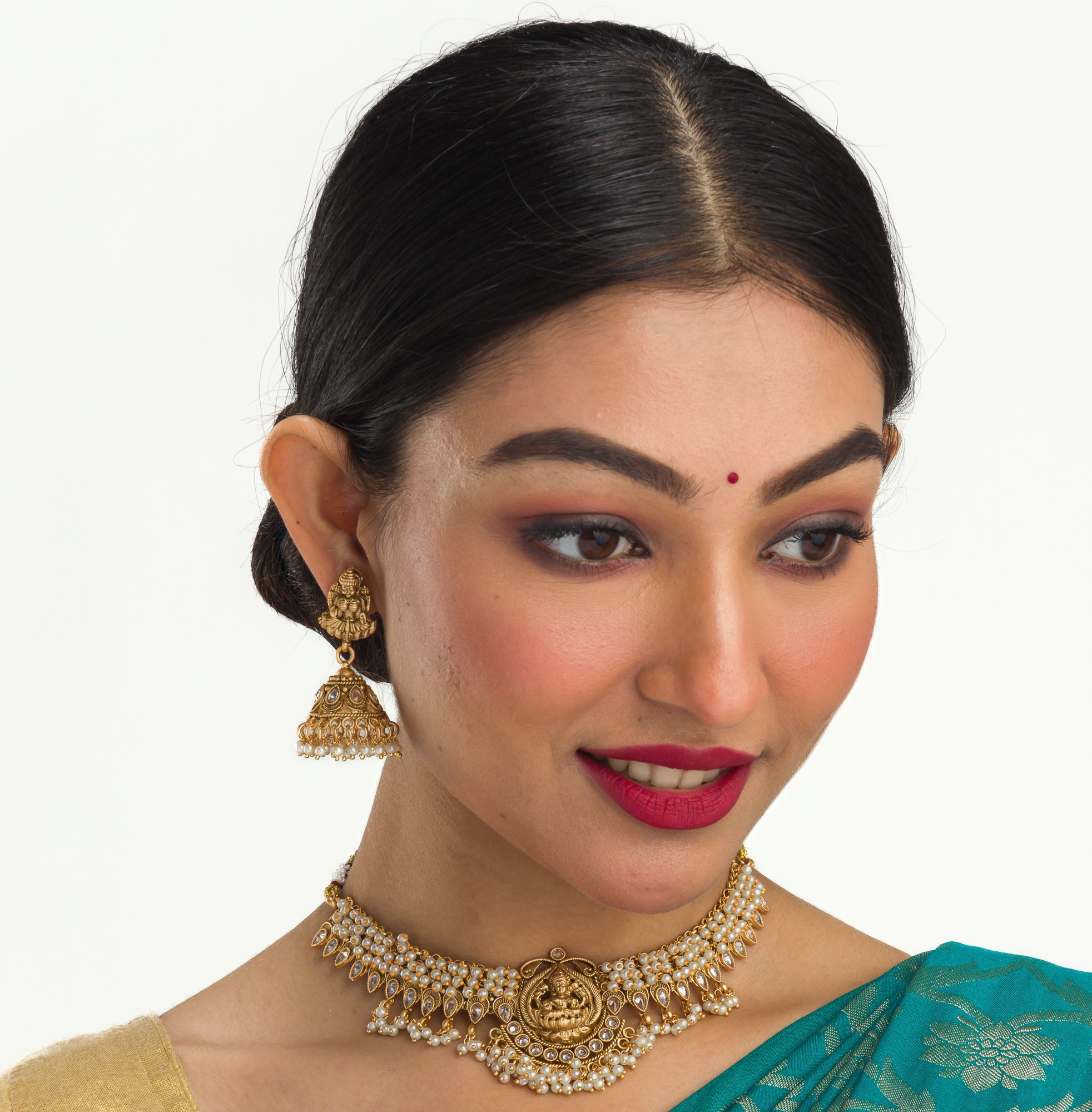 Graceful temple necklace with white pearls adds a touch of classic festival sophistication.