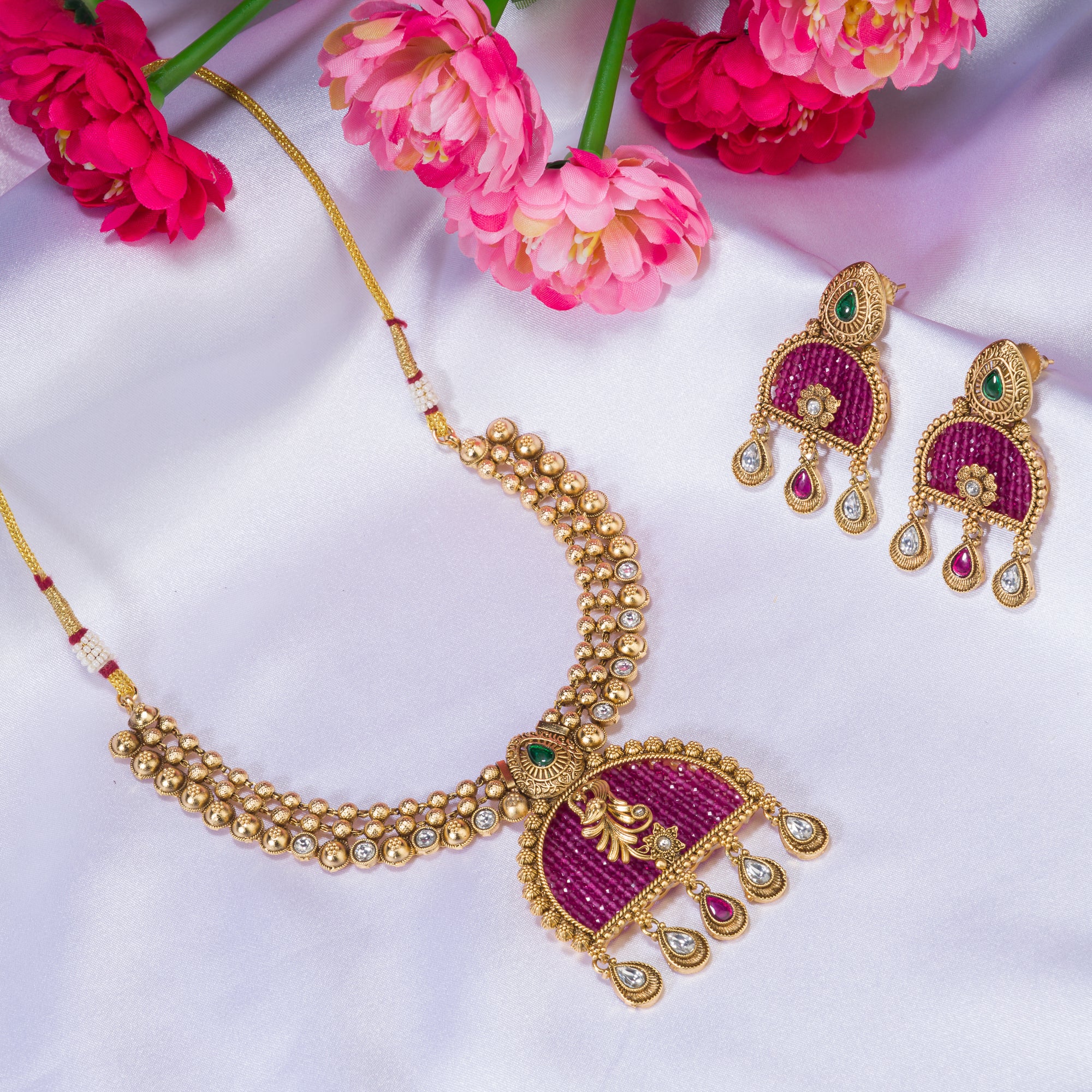 Elegant pink gold-tone short necklace exudes understated charm for a graceful festival look.