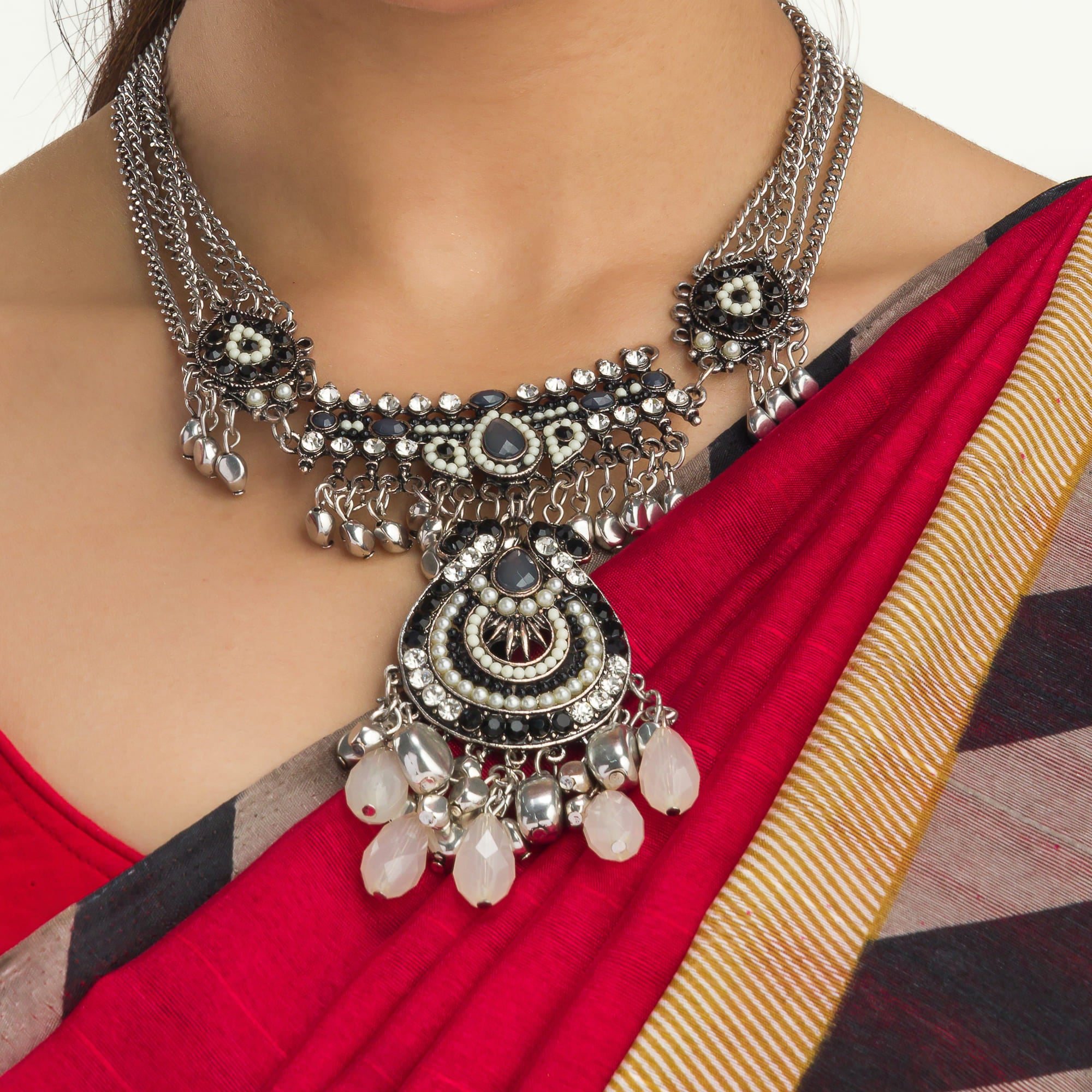 "Oxidized silver necklace with black and white beads adds stylish contrast."