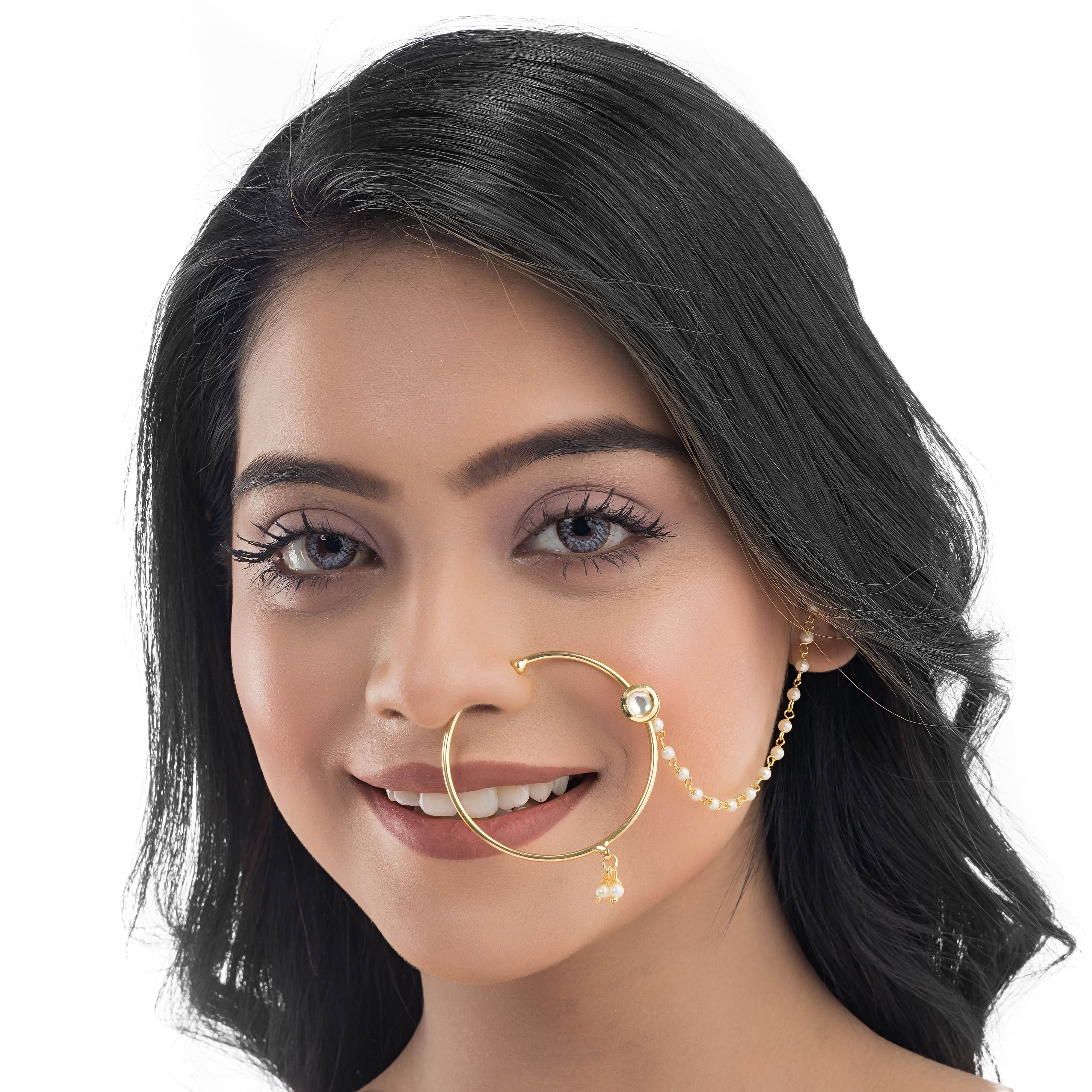 "Gold-polish nath with white pearls offers classic, elegant charm."