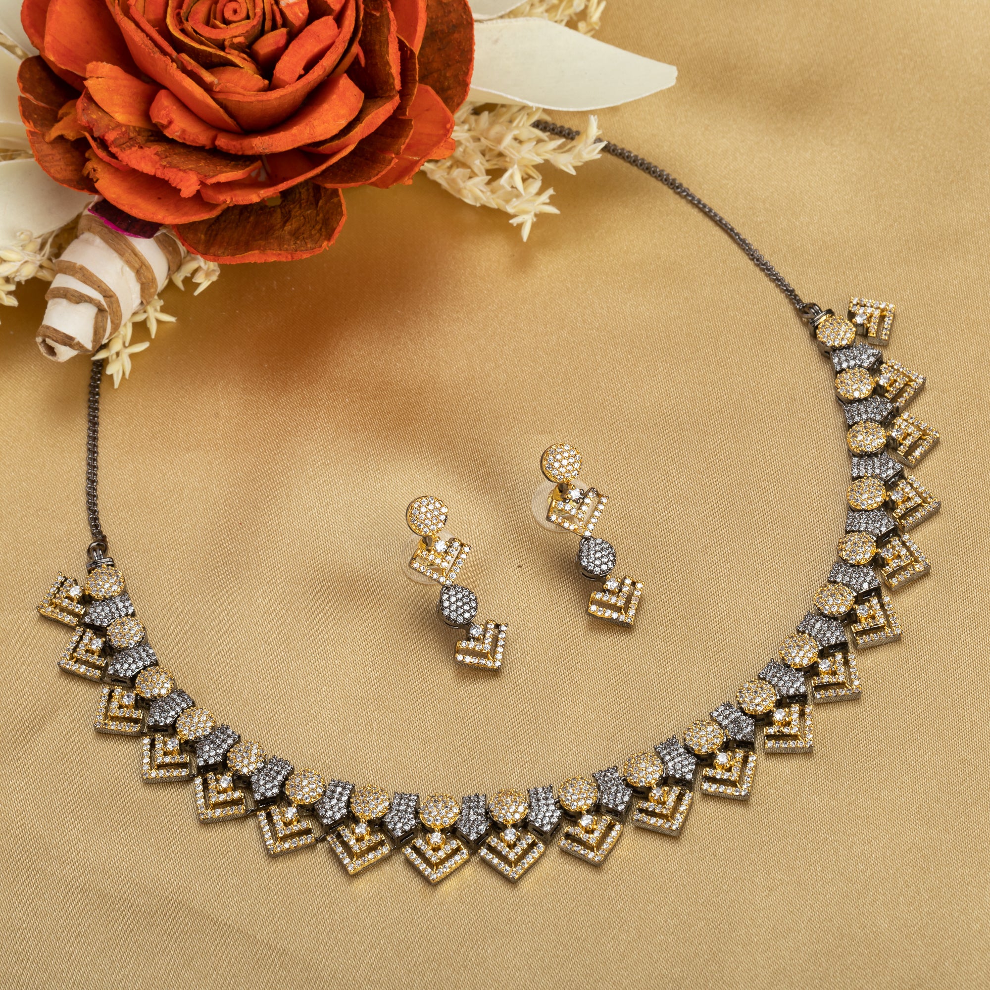 Black polished necklace set with golden and white zircon stones for an elegant and striking contrast.