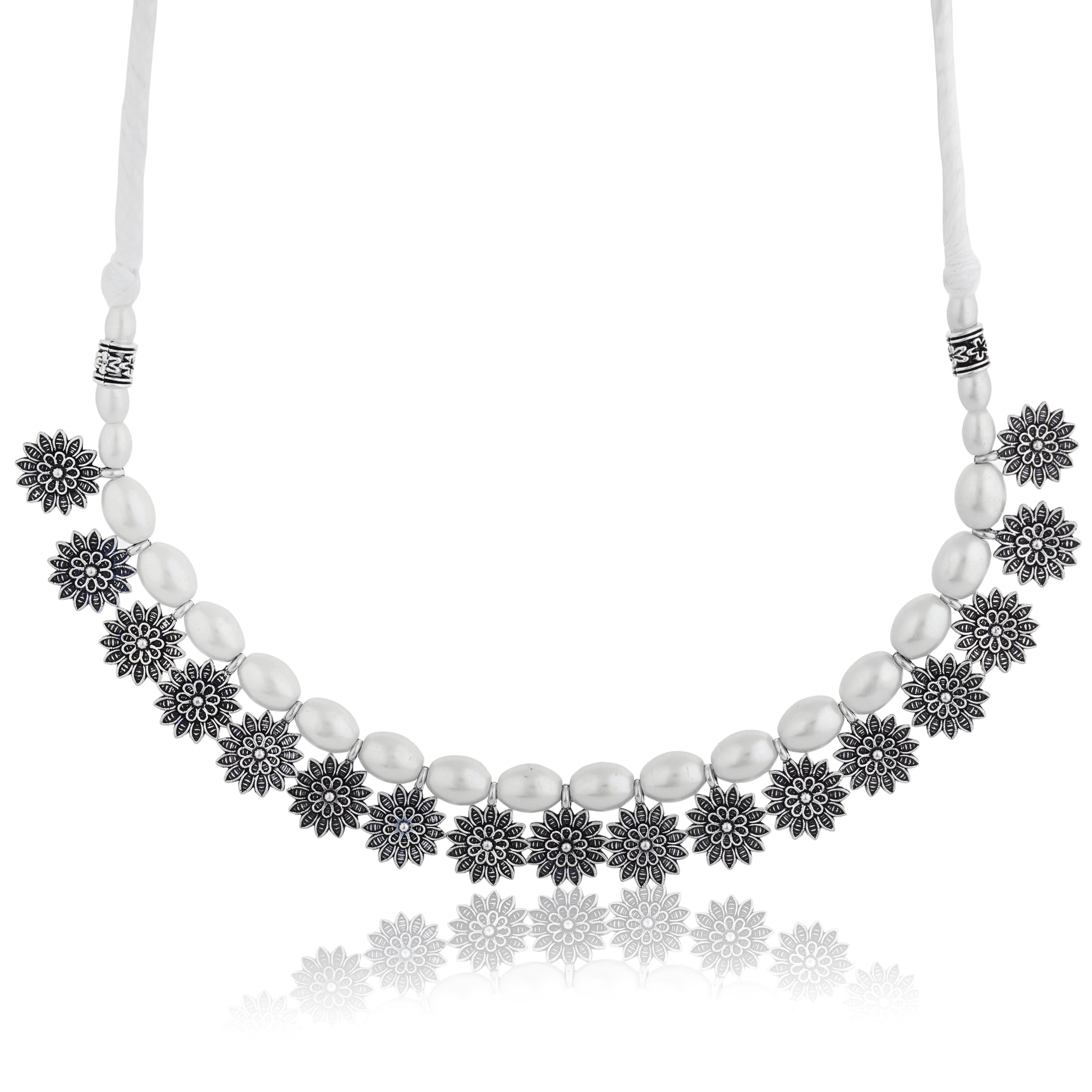 Stylish oxidized choker with floral design and white pearls, adding vintage charm to festive looks.