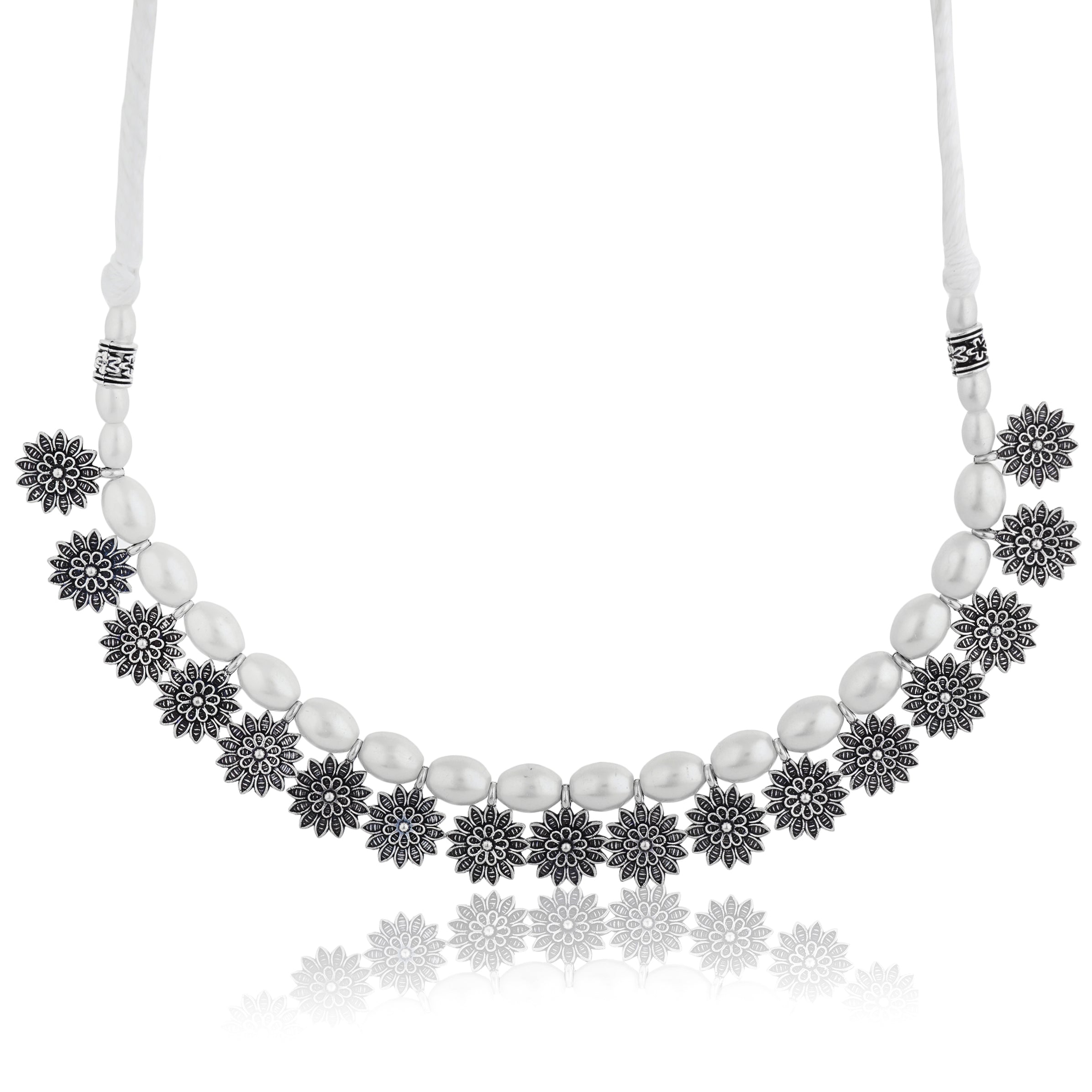 Stylish oxidized choker with floral design and white pearls, adding vintage charm to festive looks.