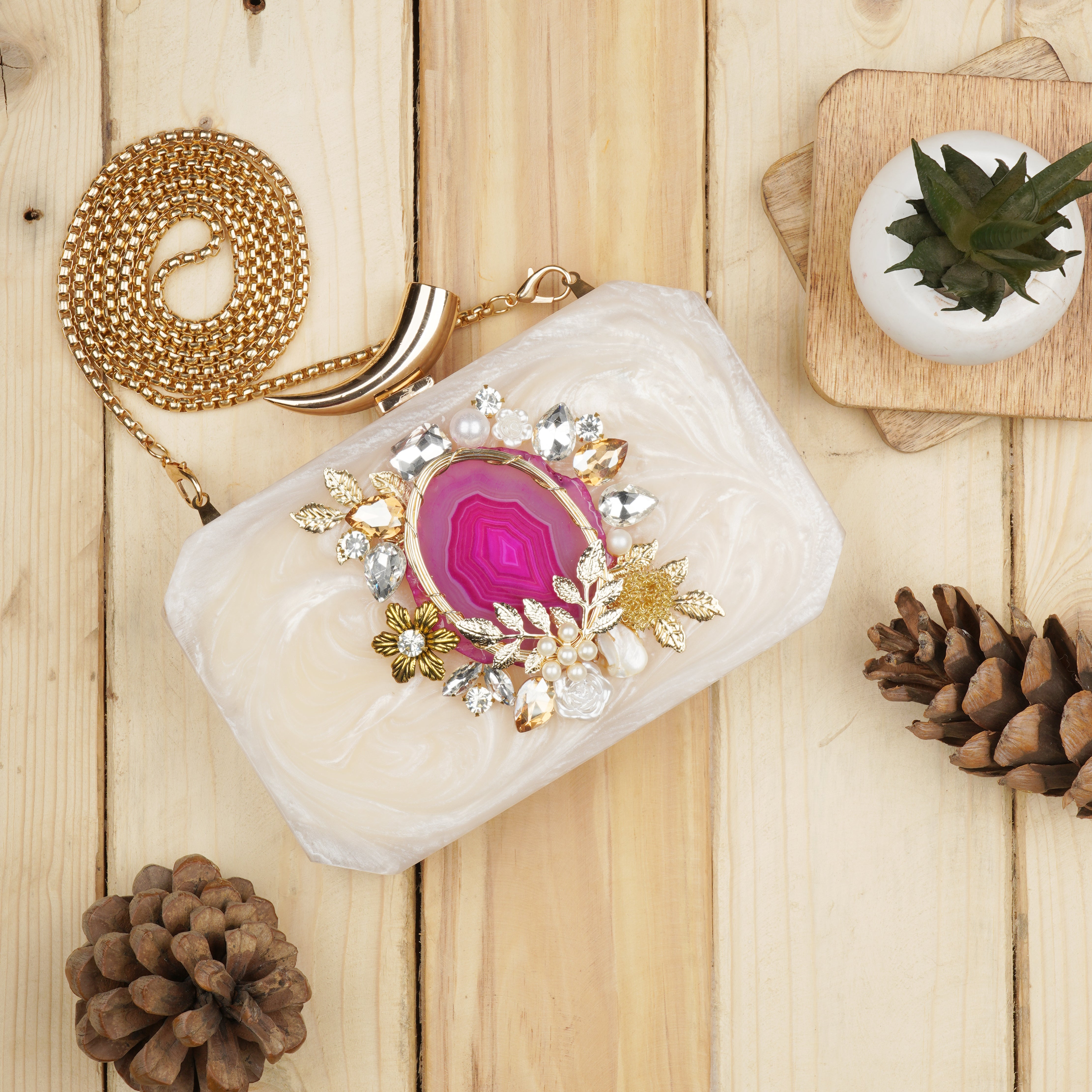 Resin-embellished clutch featuring a pink agate stone, paired with a stylish sling chain.