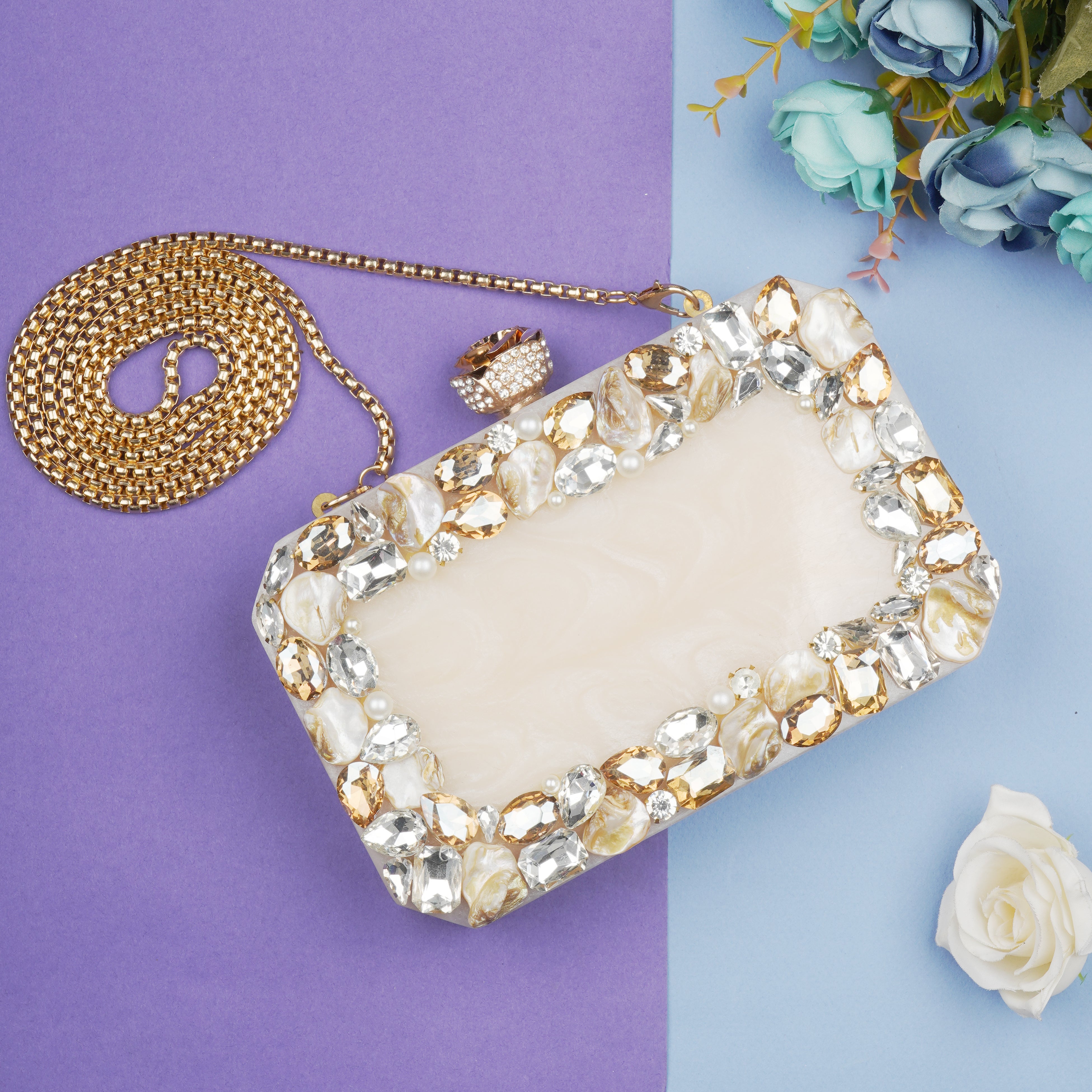 Resin-embellished salmon clutch with rose knob, sturdy sling, and extra pocket for convenience.