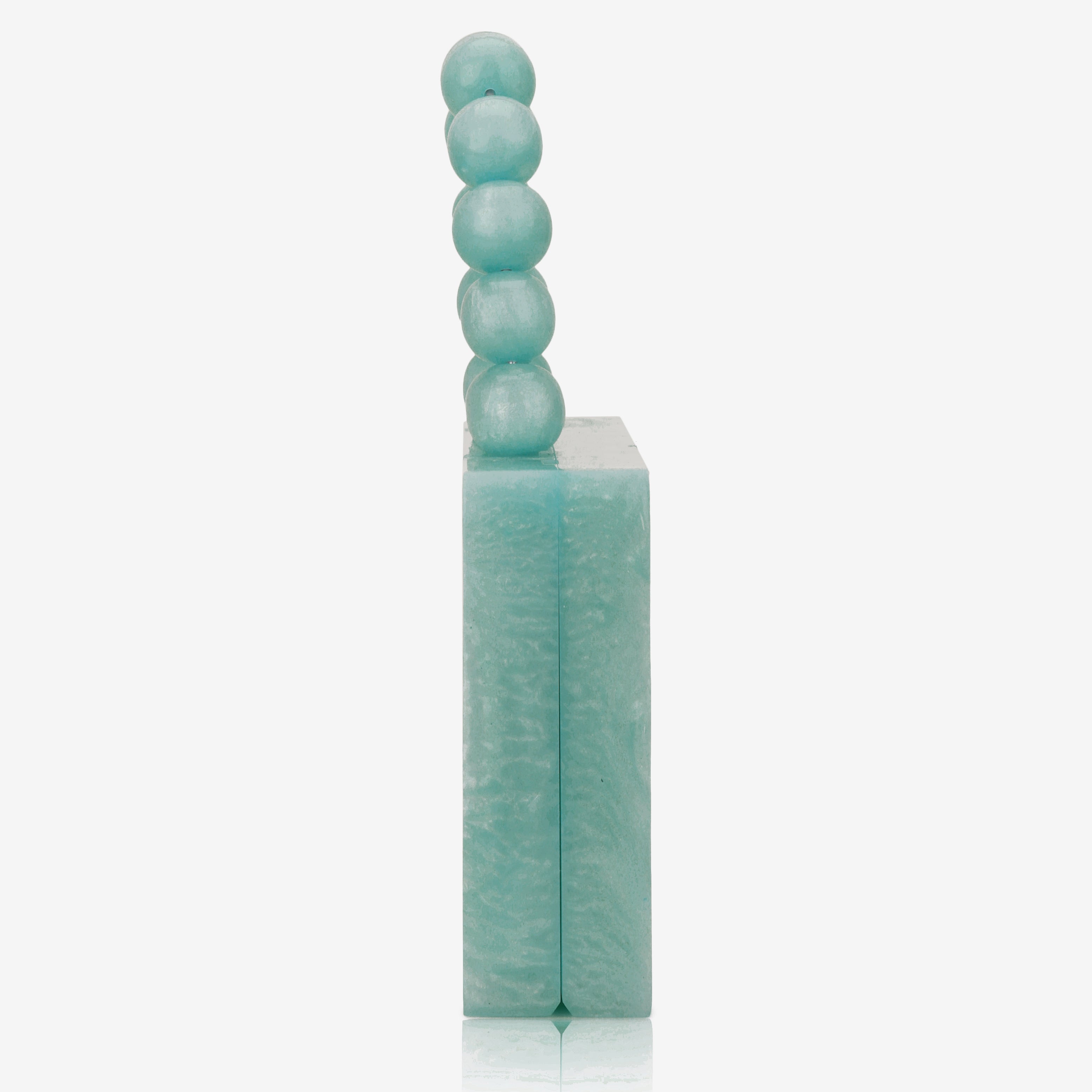 Green resin clutch with velvet lining, heavy-duty sling, and extra pocket for stylish storage.