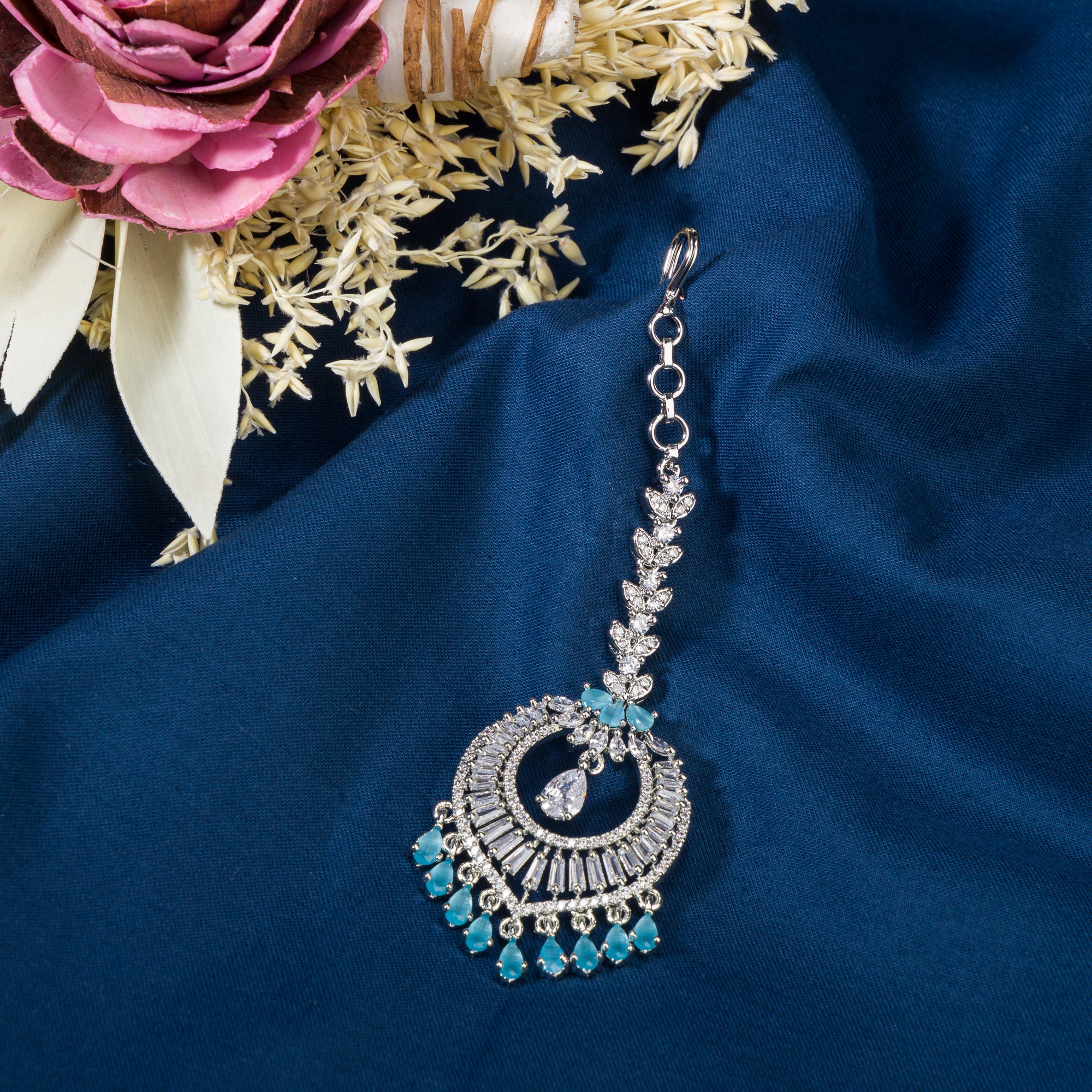 Aqua blue zircon maang tika in silver, perfect for party wear, adding a vibrant and elegant accent
