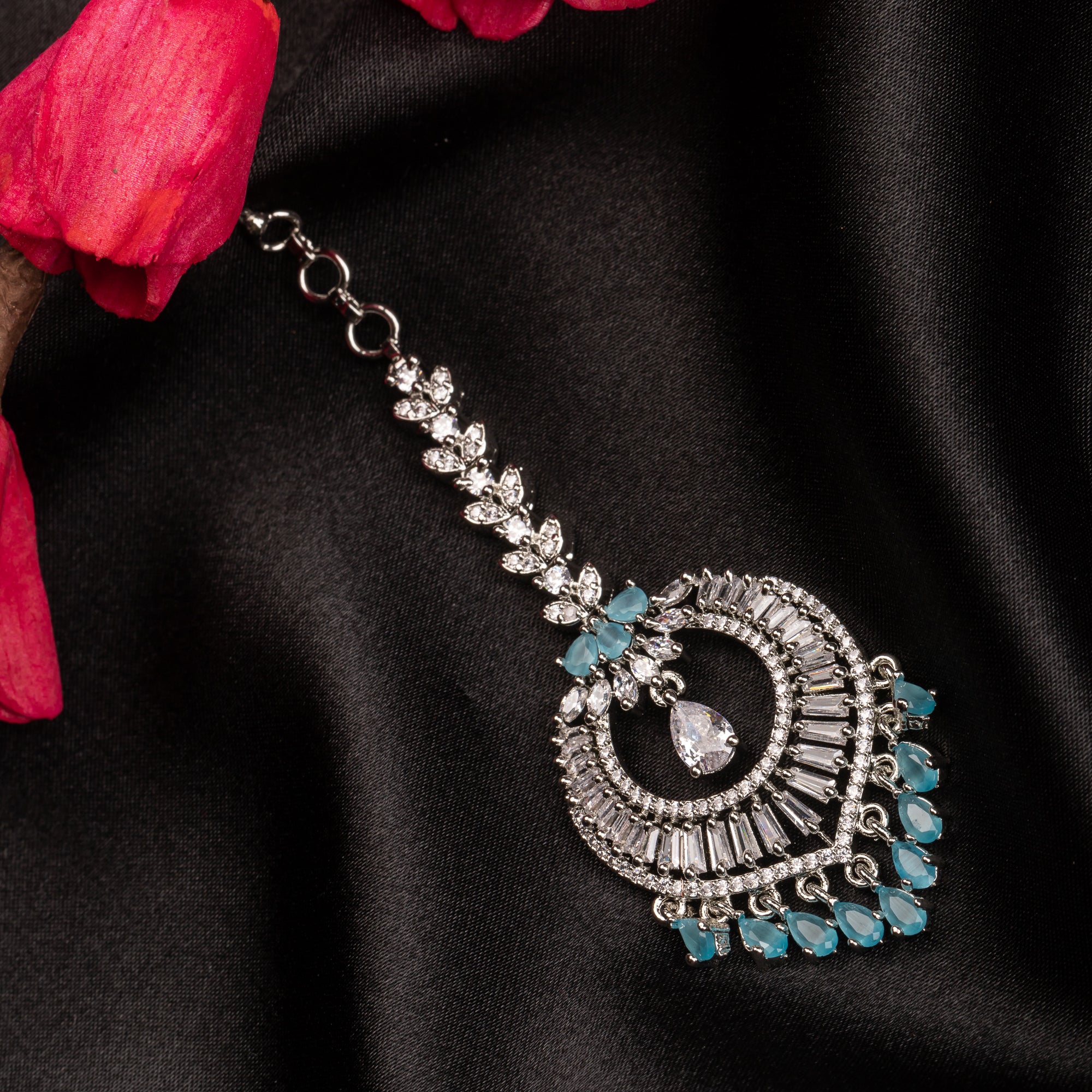 Aqua blue zircon maang tika in silver, perfect for party wear, adding a vibrant and elegant accent
