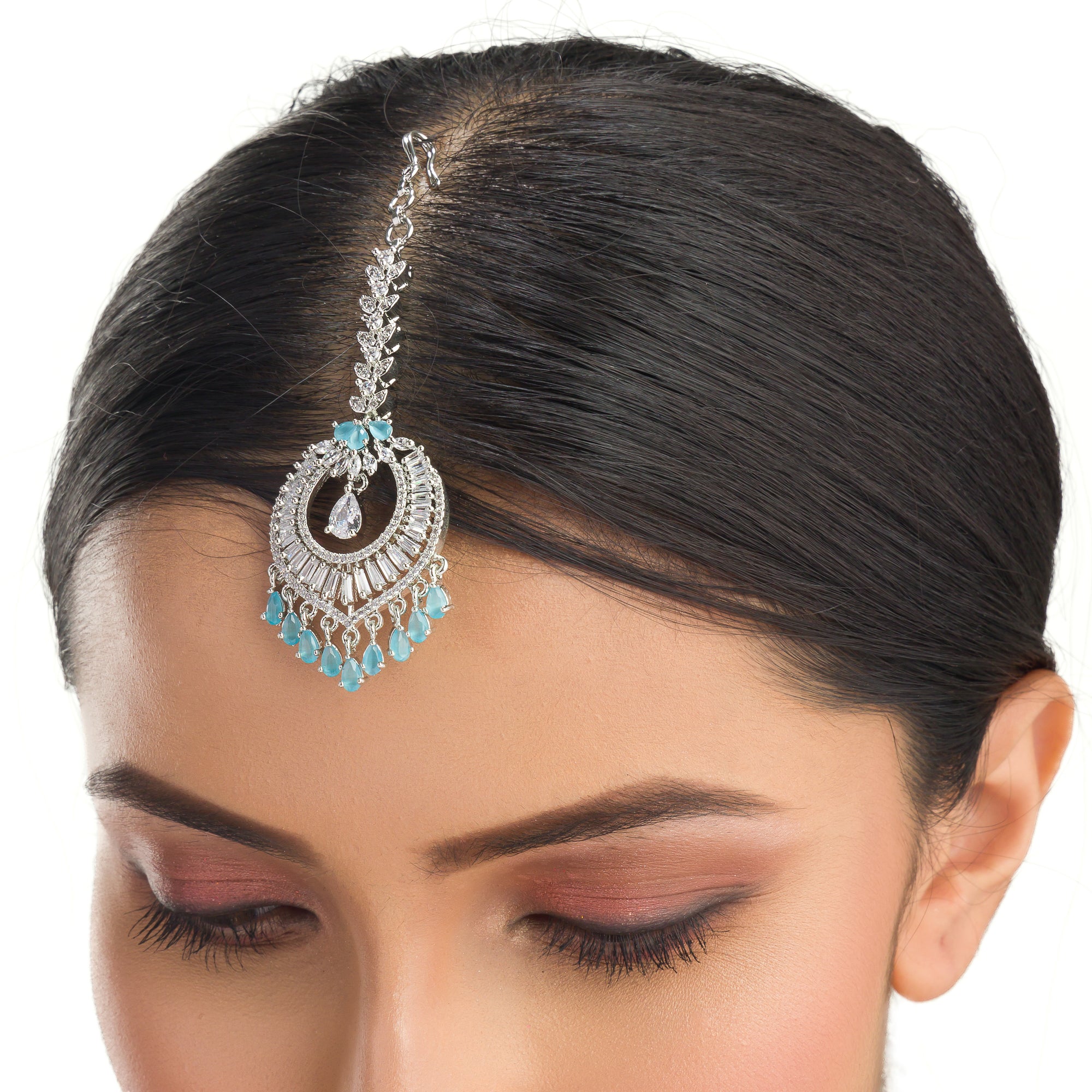 Aqua blue zircon maang tika in silver, perfect for party wear, adding a vibrant and elegant accent
