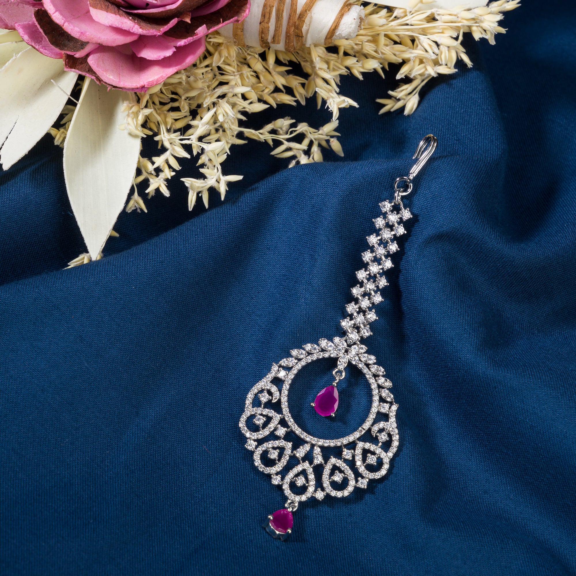 Pink zircon maang tika in silver, perfect for party wear, adding a chic touch of color and elegance
