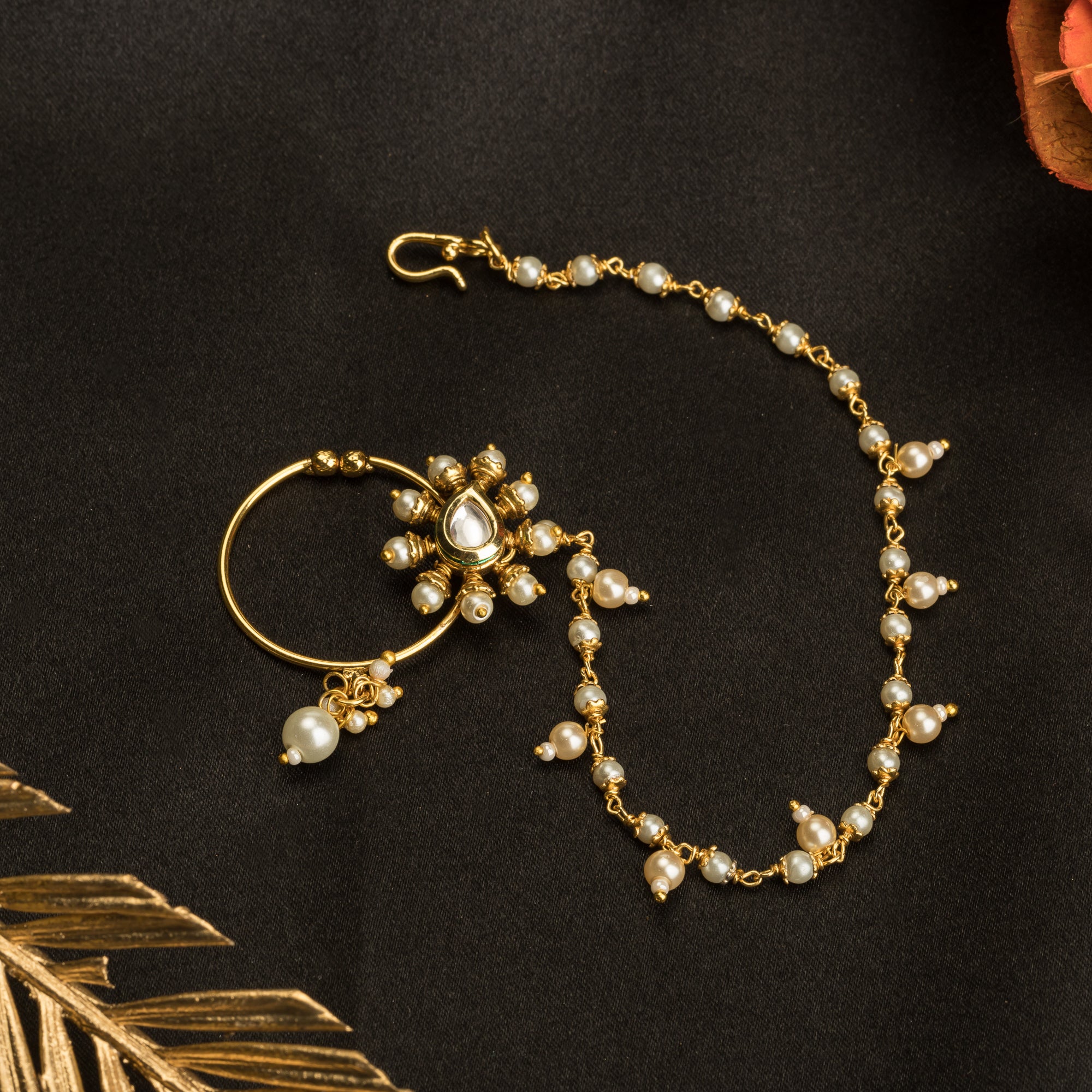 "Elegant gold-tone nose pin with pearls, perfect for festival wear, blending tradition and sophistication."
