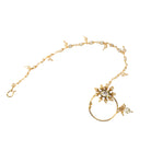 "Elegant gold-tone nose pin with pearls, perfect for festival wear, blending tradition and sophistication."
