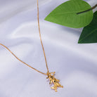 "Gold-tone pendant of a boy with a bow (dhanush), perfect for casual wear, adding a playful touch."
