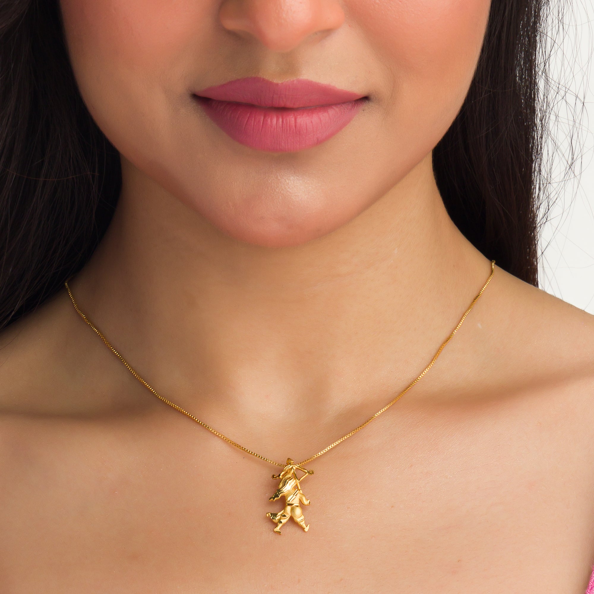 "Gold-tone pendant of a boy with a bow (dhanush), perfect for casual wear, adding a playful touch."
