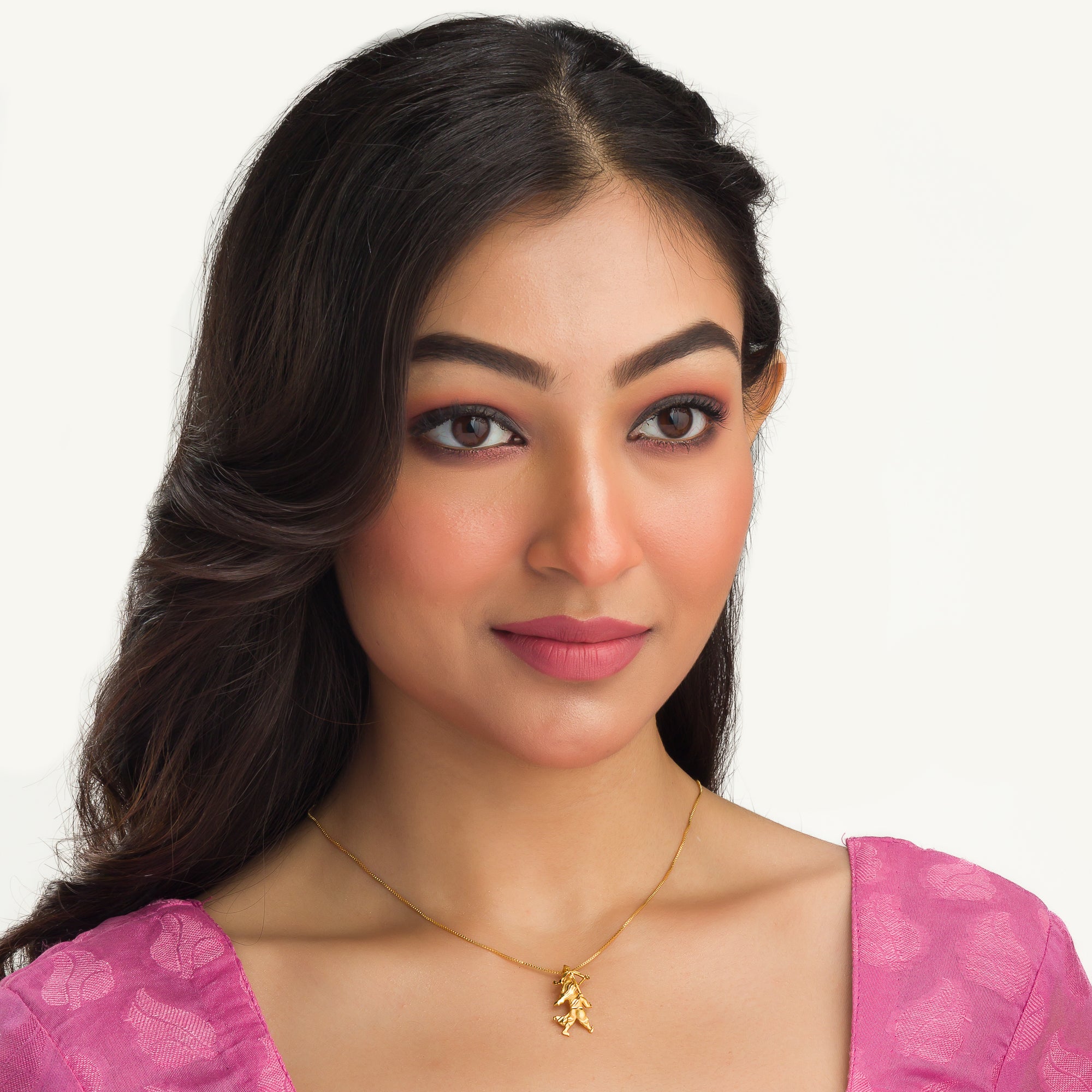 "Gold-tone pendant of a boy with a bow (dhanush), perfect for casual wear, adding a playful touch."
