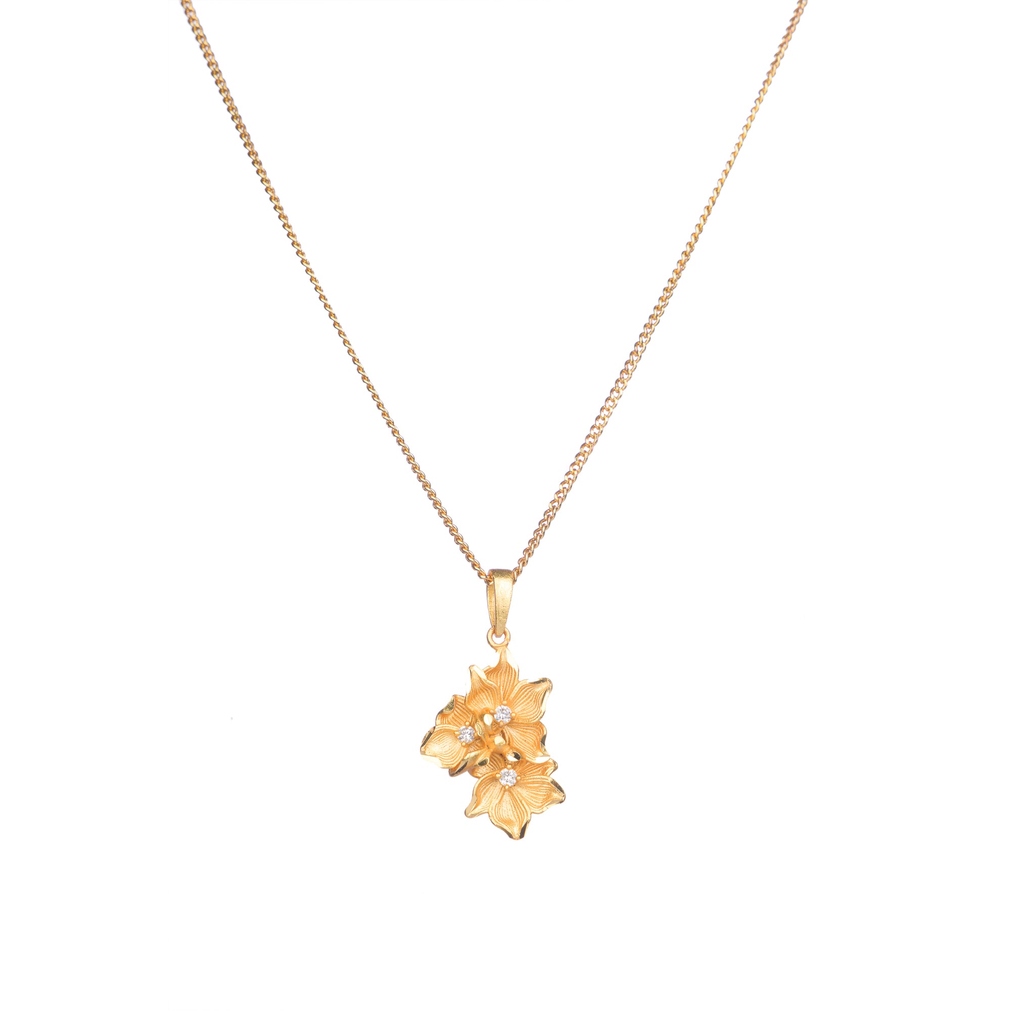 "Gold-tone pendant featuring three flowers, perfect for casual wear, offering a charming, delicate look."
