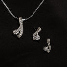 "Elegant zircon pendant set for neck and ear, perfect for casual wear, featuring a stylish '&' shape."
