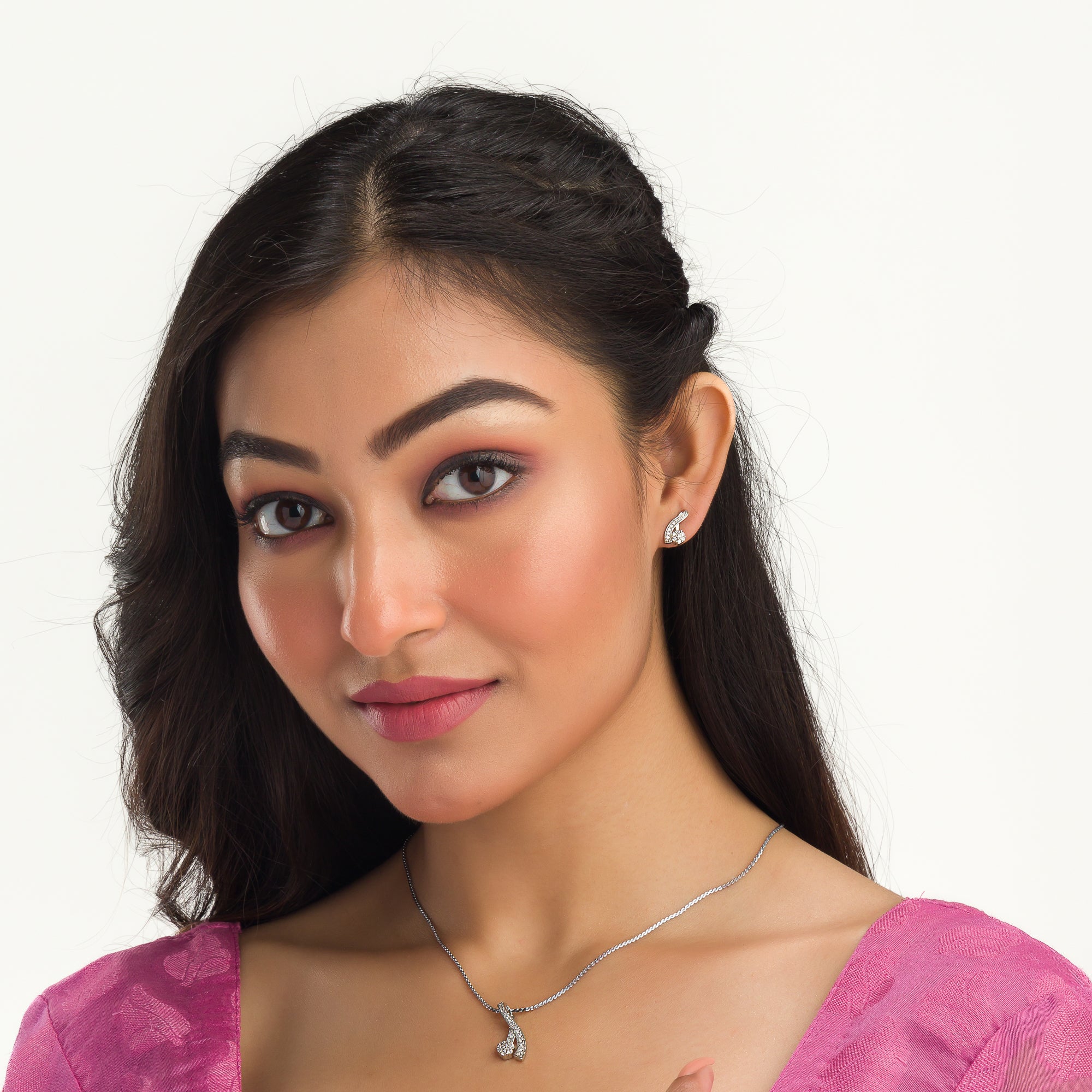 "Elegant zircon pendant set for neck and ear, perfect for casual wear, featuring a stylish '&' shape."
