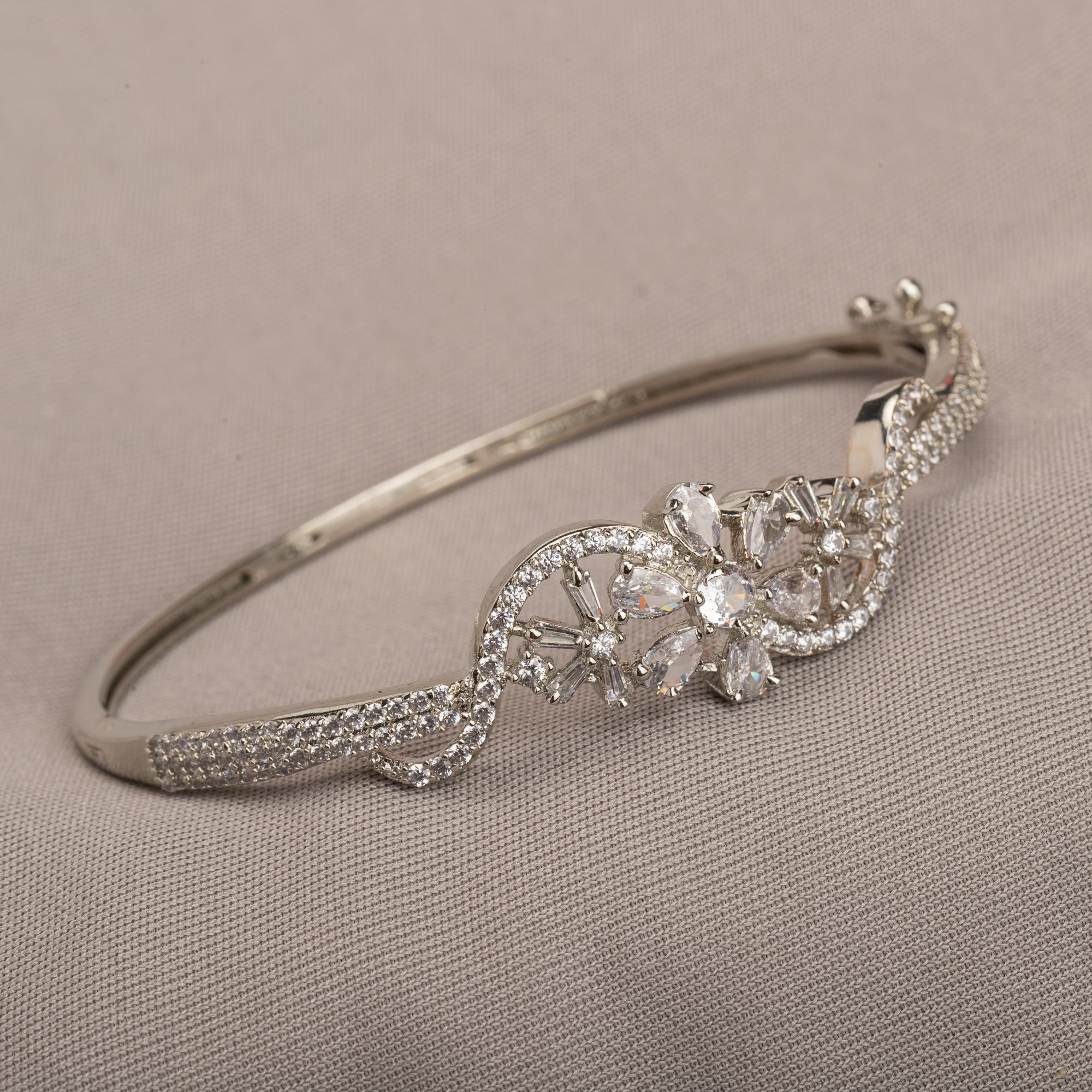 "Brilliant zircon bracelet in silver, showcasing dazzling clarity and gem-like radiance, ideal for party wear."
