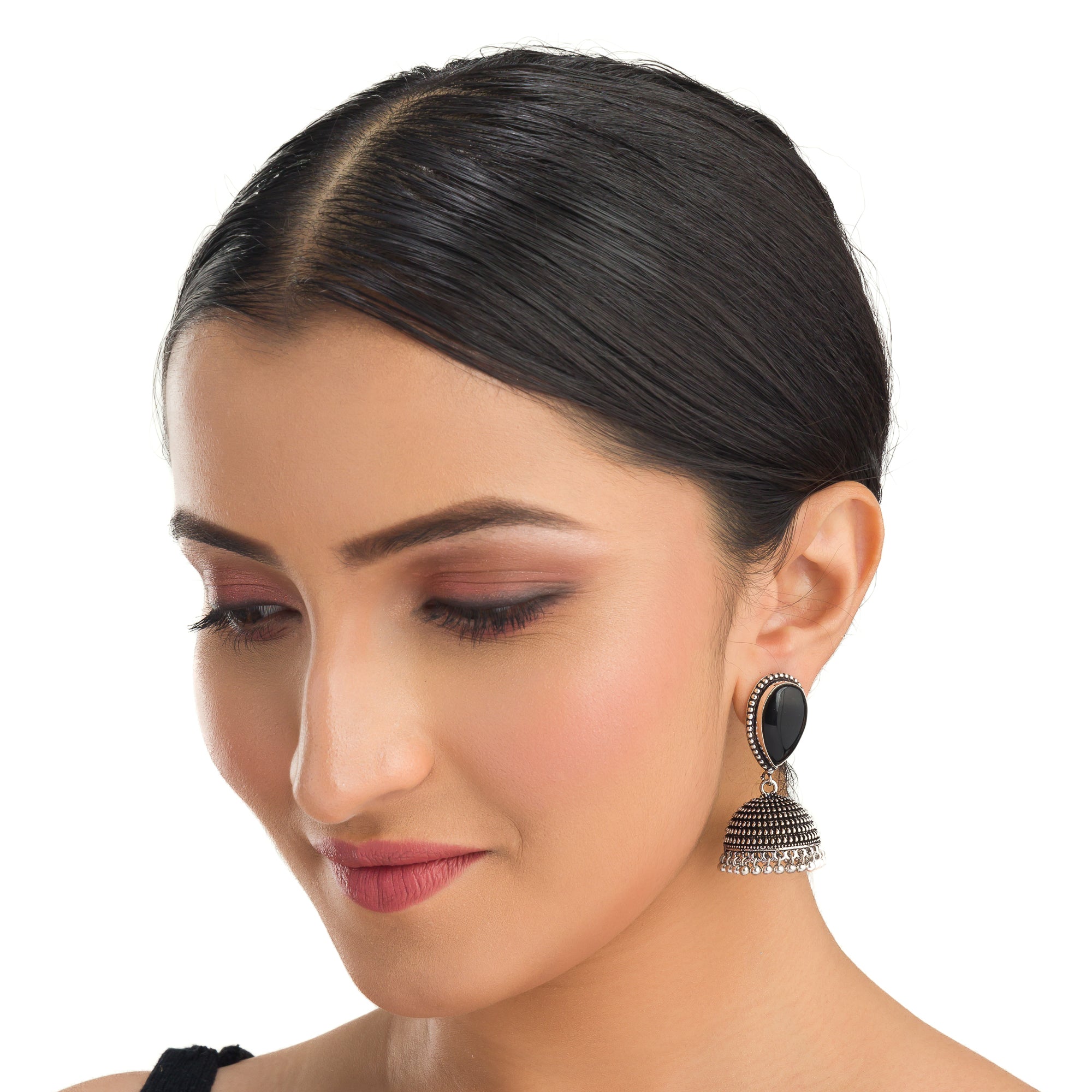 "Oxidized jhumka earrings with a black stone center deliver a striking vintage allure for festivals."

