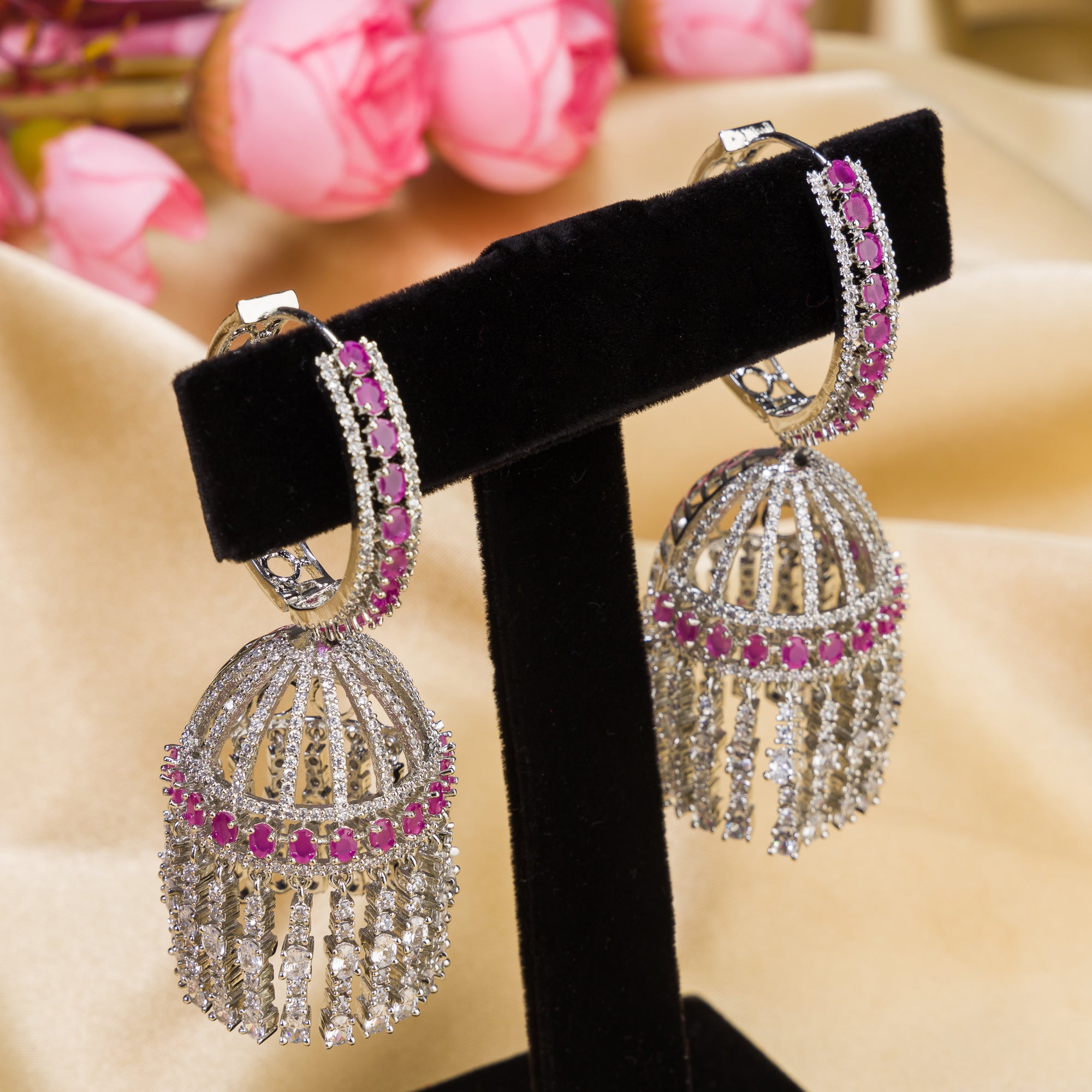 "Pink zircon big jhumka features vibrant design with intricate detailing for a bold look."
