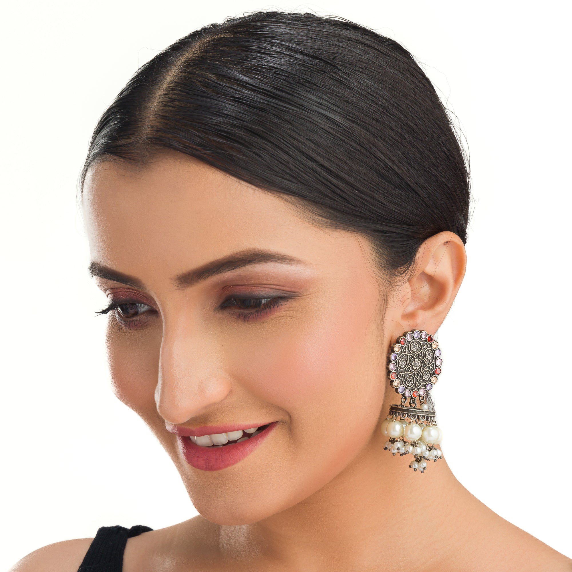 "Oxidized earrings with multi-color stones and pearls add a vibrant, bohemian touch."
