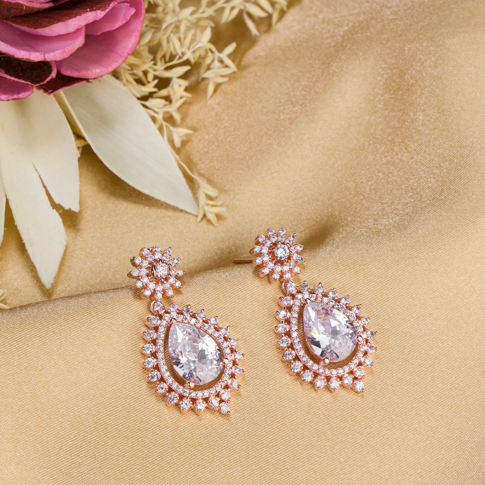 "Rose gold zircon earrings add elegance and sparkle to any look with timeless shine."
