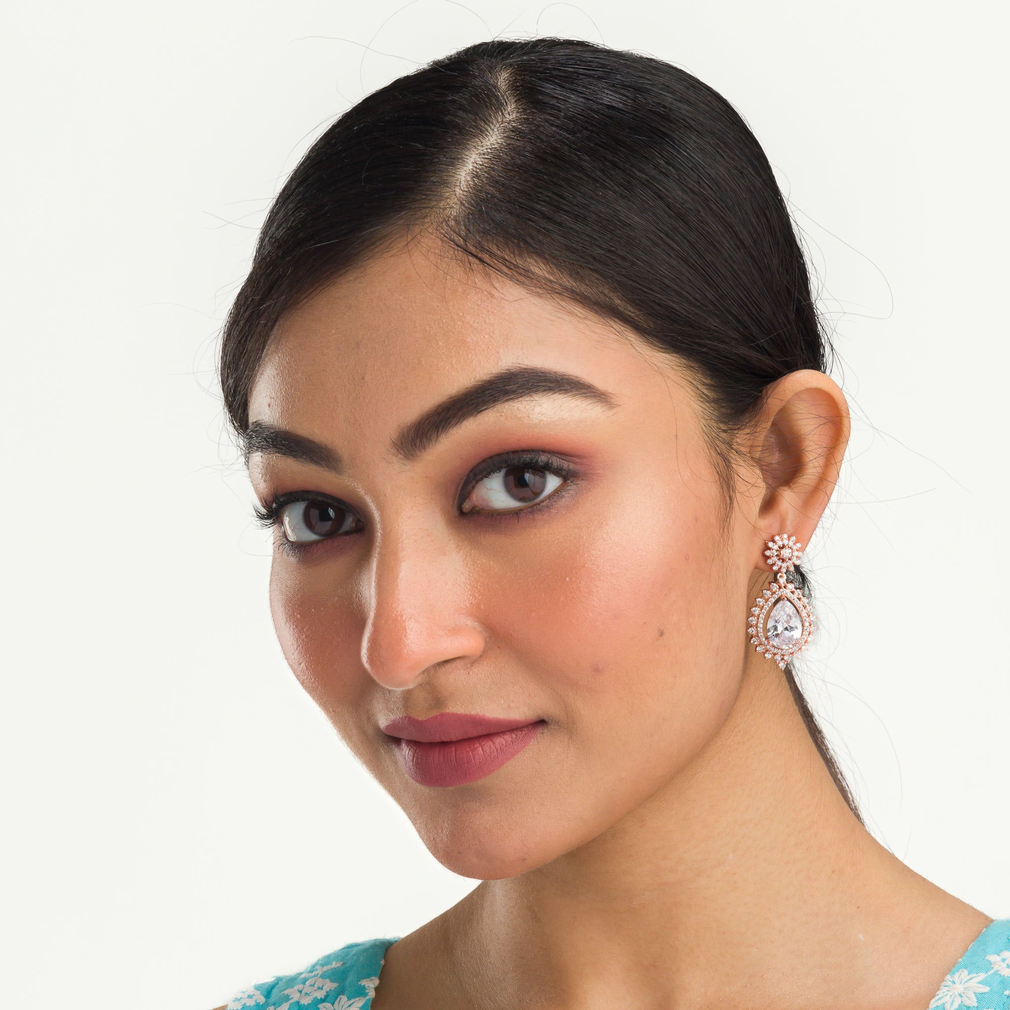 "Rose gold zircon earrings add elegance and sparkle to any look with timeless shine."
