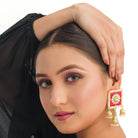 1. "Red square gold jhumka blends bold color and classic elegance for a striking look."
