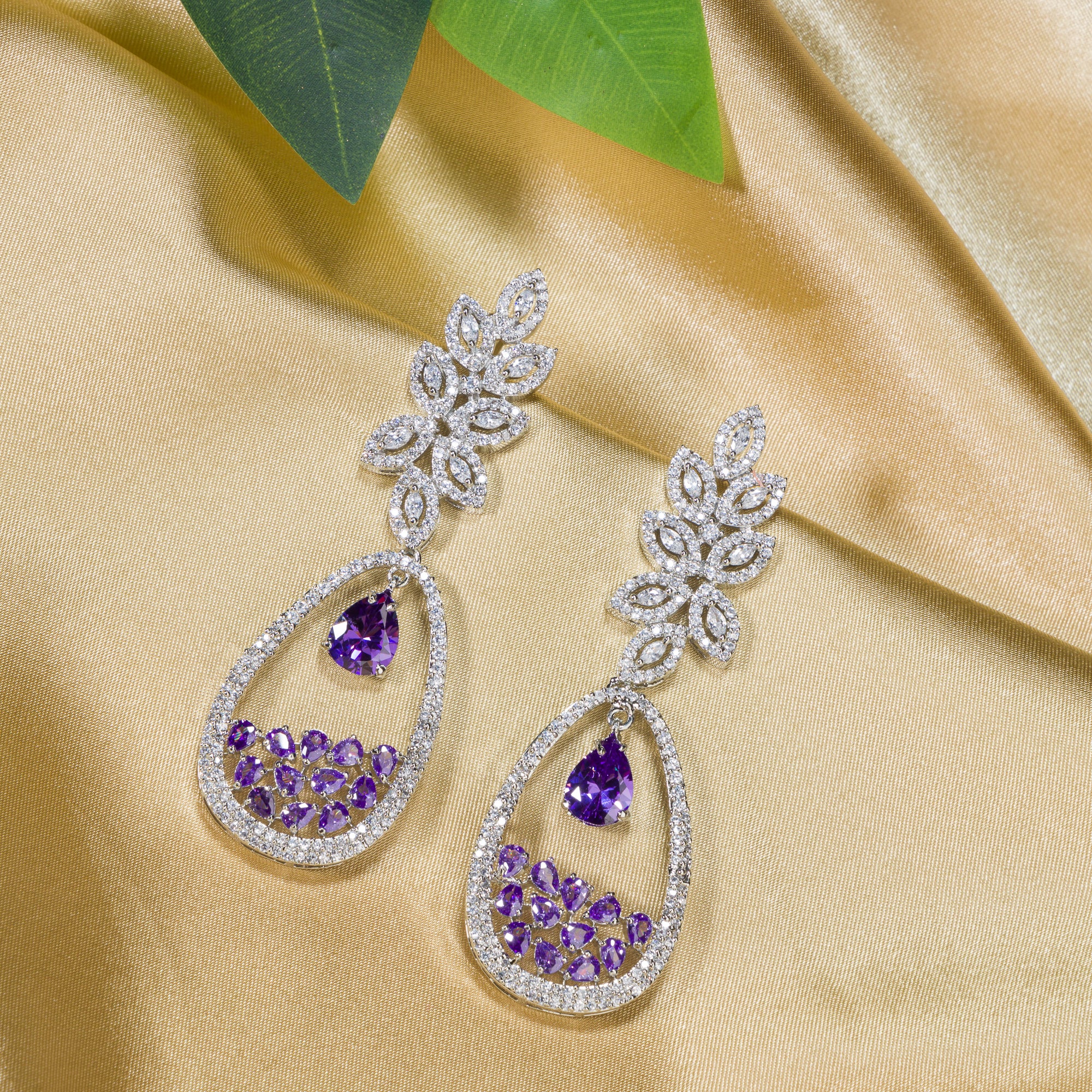 "Dark blue zircon dangler earrings offer a captivating, deep sparkle for a bold look."

