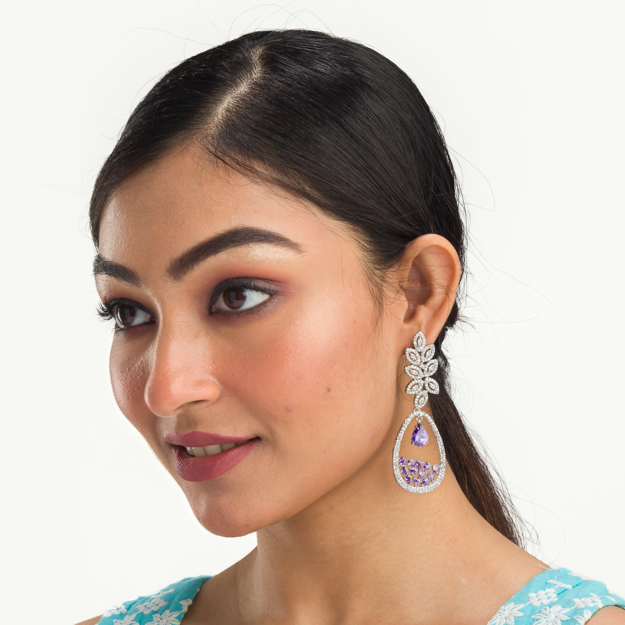 "Dark blue zircon dangler earrings offer a captivating, deep sparkle for a bold look."
