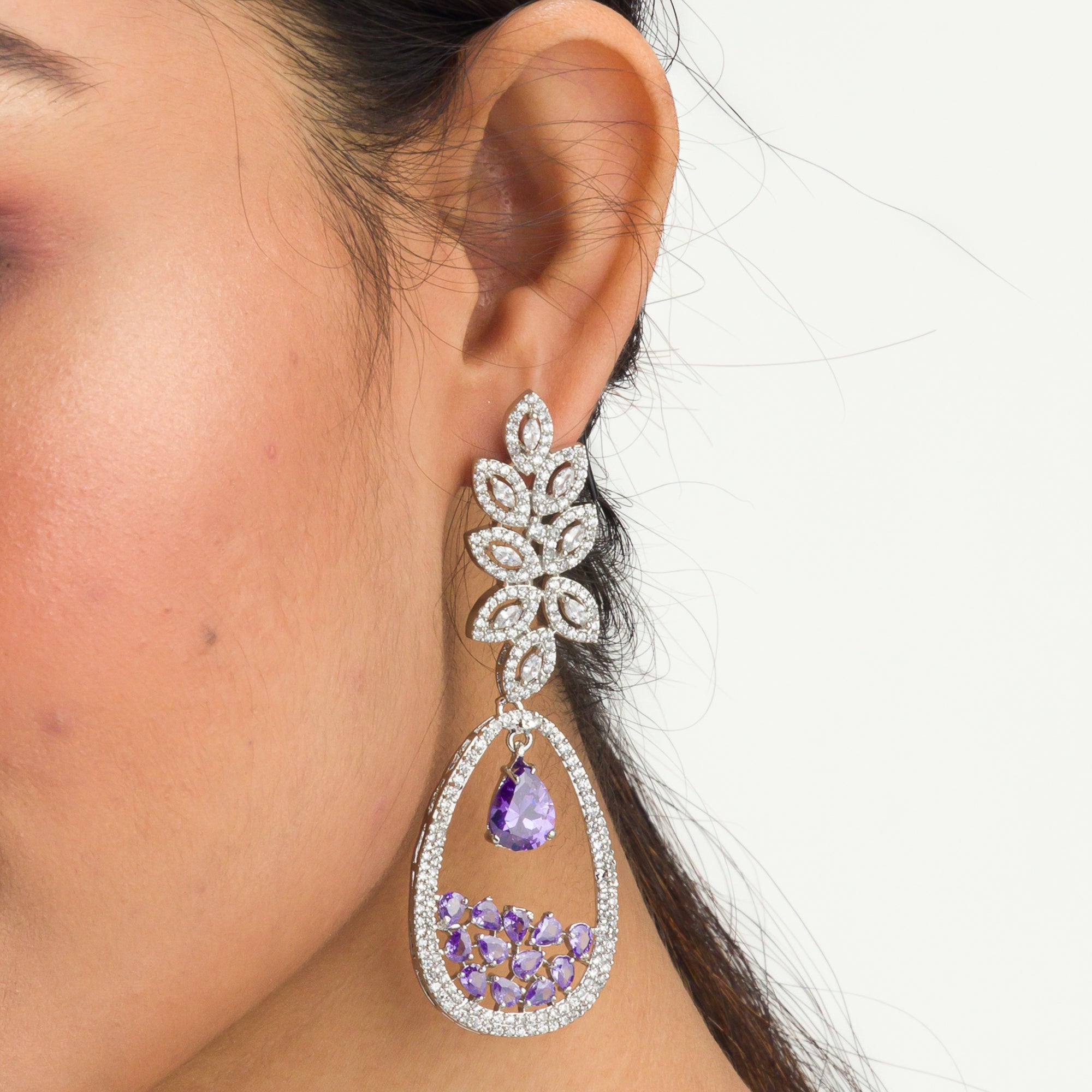"Dark blue zircon dangler earrings offer a captivating, deep sparkle for a bold look."
