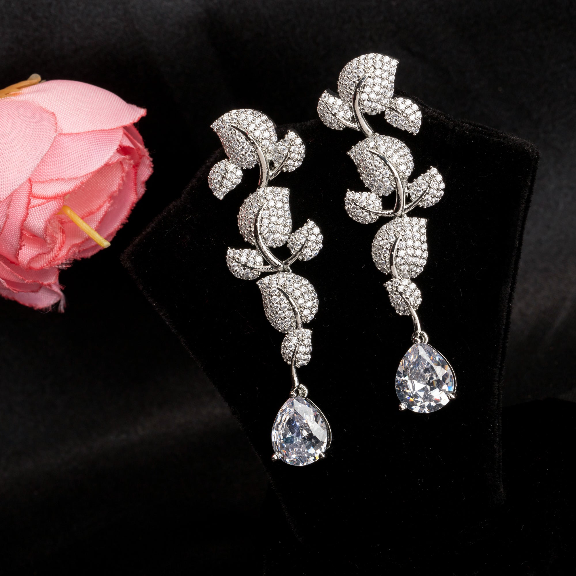 "Leaf design zircon earrings blend nature’s beauty with radiant zircon accents."
