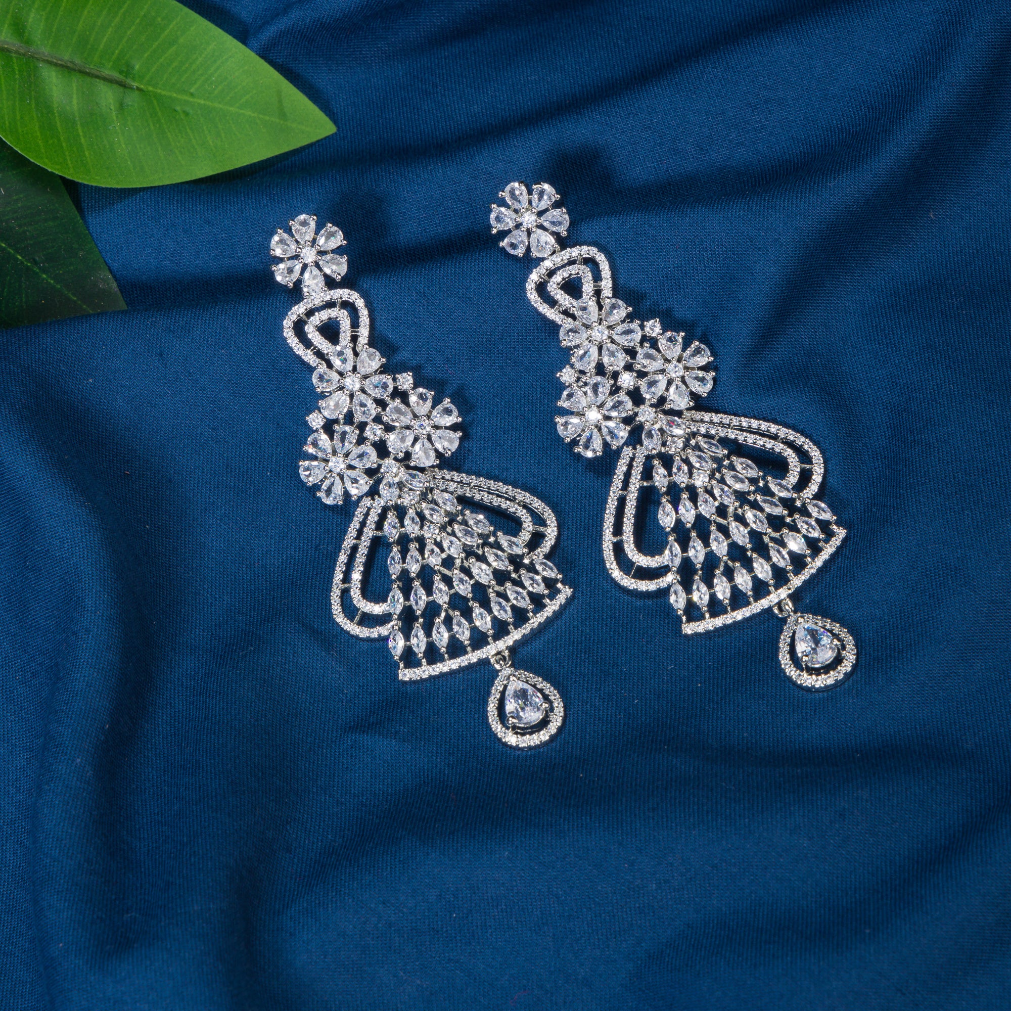 "Zircon dangler earrings sparkle with deep, captivating brilliance, perfect for any occasion."
