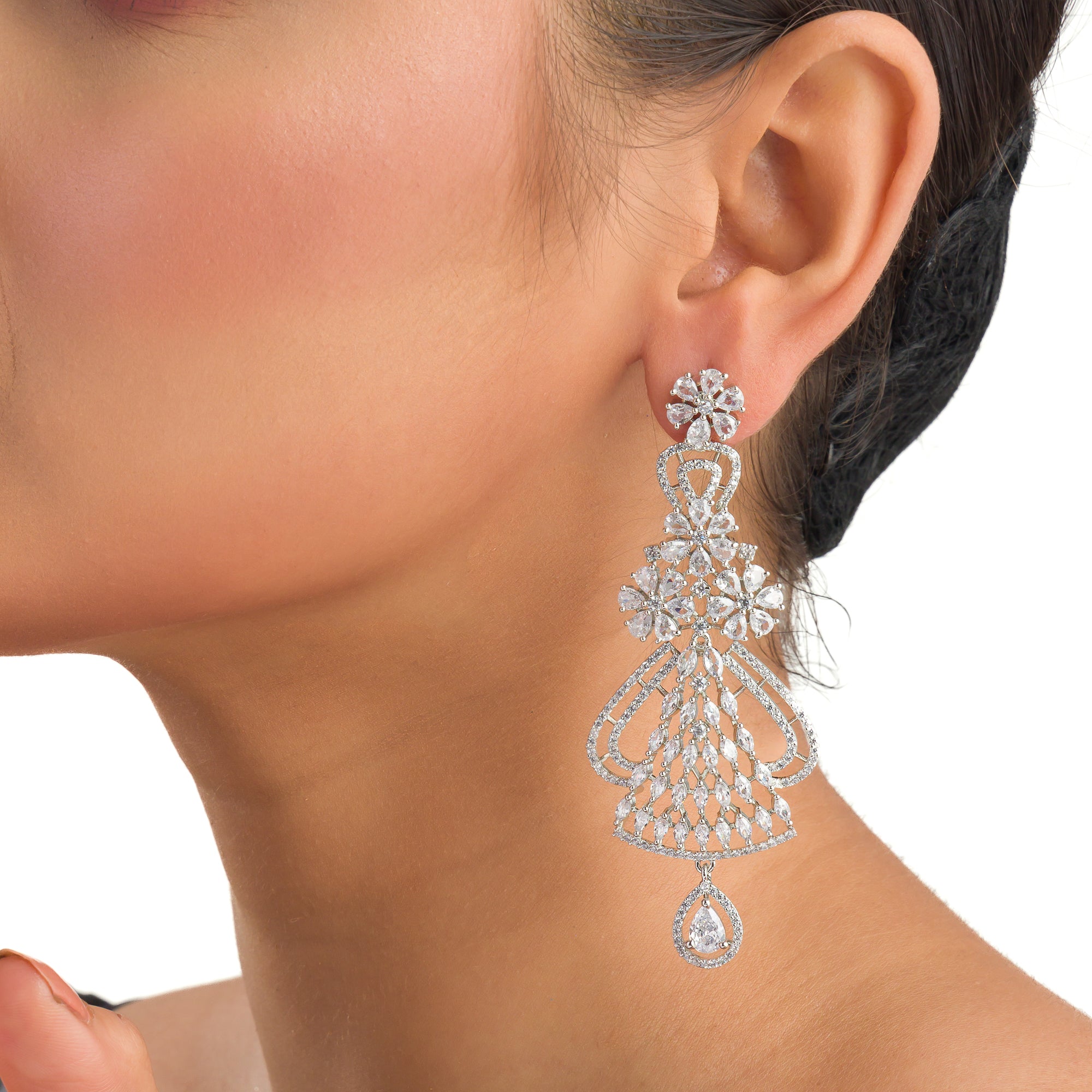 "Zircon dangler earrings sparkle with deep, captivating brilliance, perfect for any occasion."
