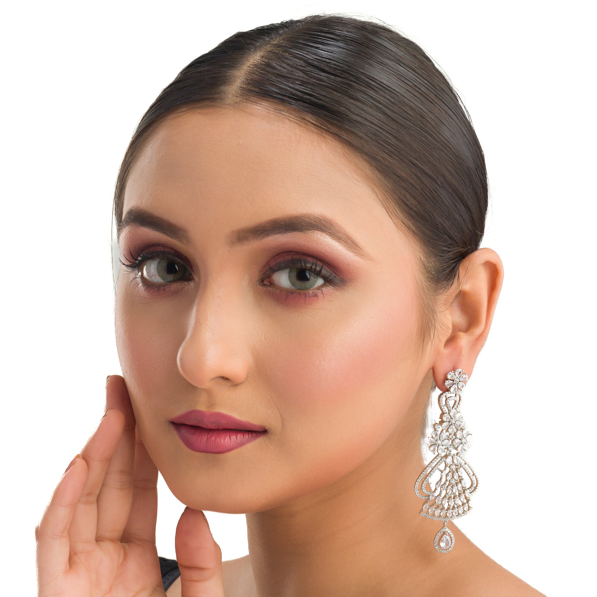 "Zircon dangler earrings sparkle with deep, captivating brilliance, perfect for any occasion."

