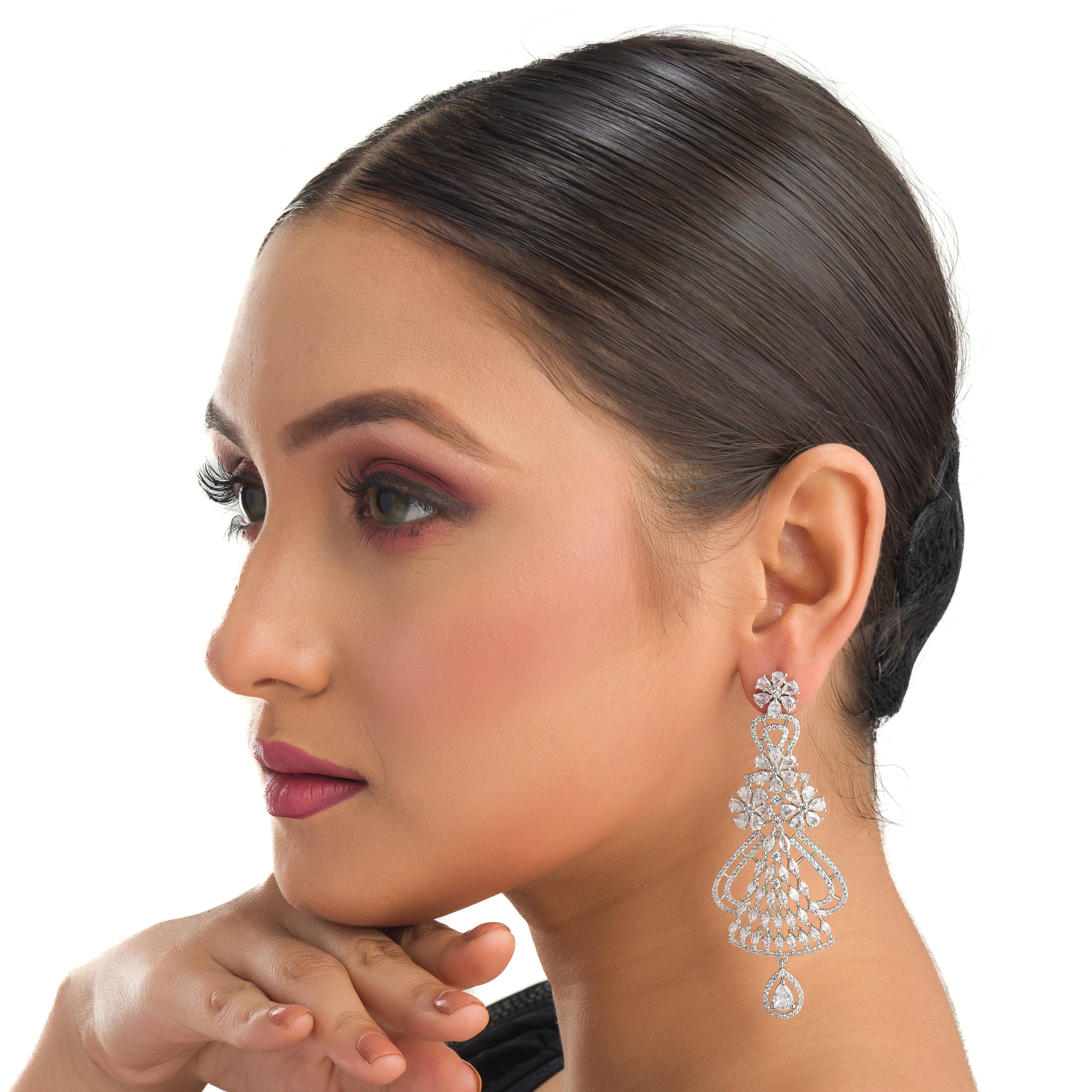 "Zircon dangler earrings sparkle with deep, captivating brilliance, perfect for any occasion."
