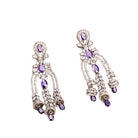 1. "Blue zircon dangler earrings shimmer with a captivating, deep sparkle for a bold look."
