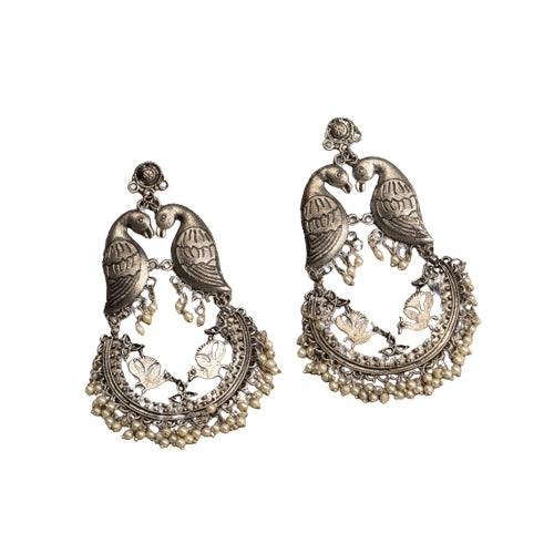 "Small oxidized earrings with two birds add vintage charm with intricate details."
