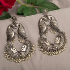 "Small oxidized earrings with two birds add vintage charm with intricate details."
