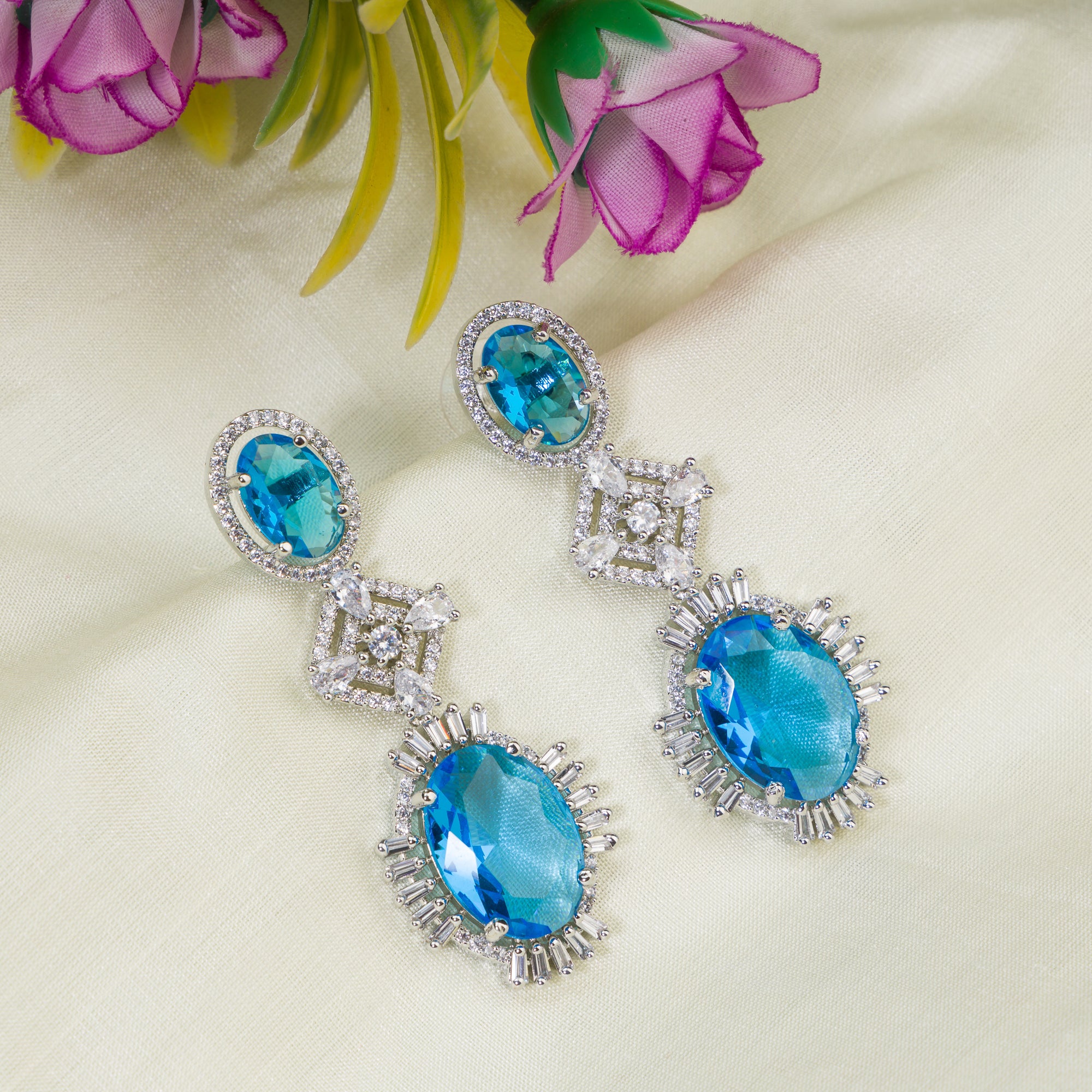 "Blue zircon dangler earrings exude a captivating sparkle, perfect for any party."
