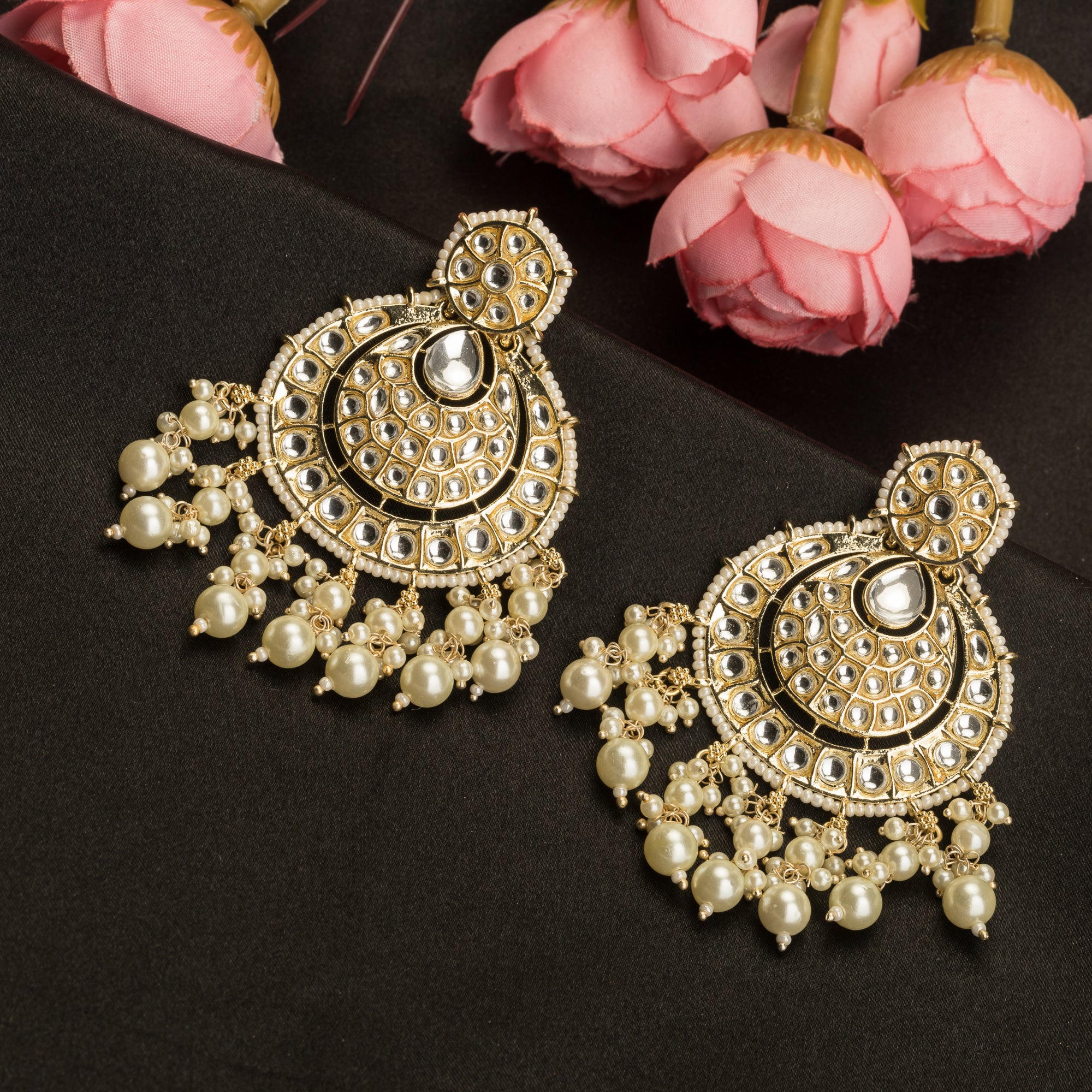 "Chandbali Kundan earrings with intricate design make a bold, regal statement."
