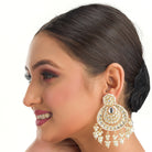 "Chandbali Kundan earrings with intricate design make a bold, regal statement."
