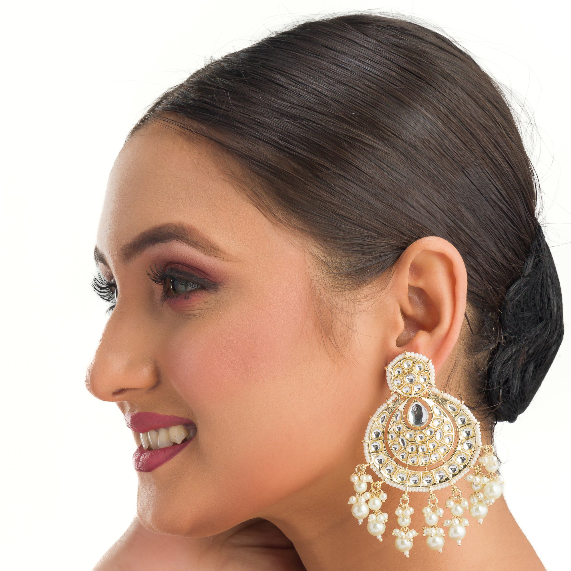 "Chandbali Kundan earrings with intricate design make a bold, regal statement."
